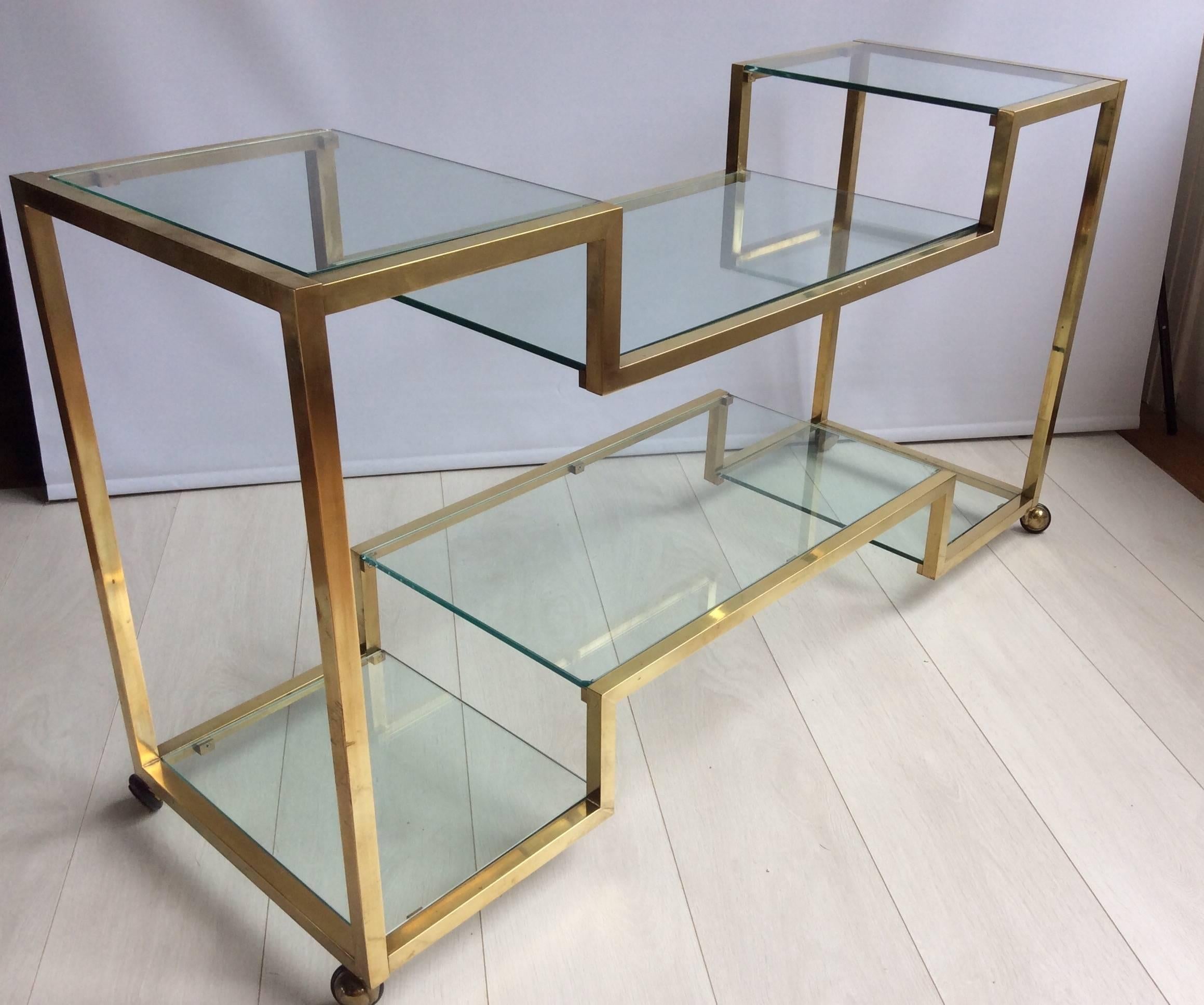 Beautiful tiered vintage brass-plated console on castors.

Aged patina.