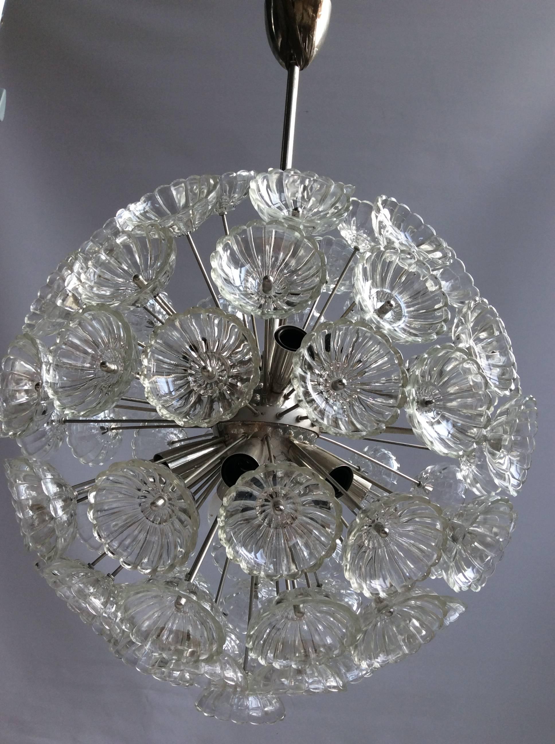 Beautiful designed sputnik chandelier from the early 1970s

Larger than usual at 50cm across, with 78 glass flowers on a chrome sputnik frame

The lamp takes 14 small Edison base bulbs.