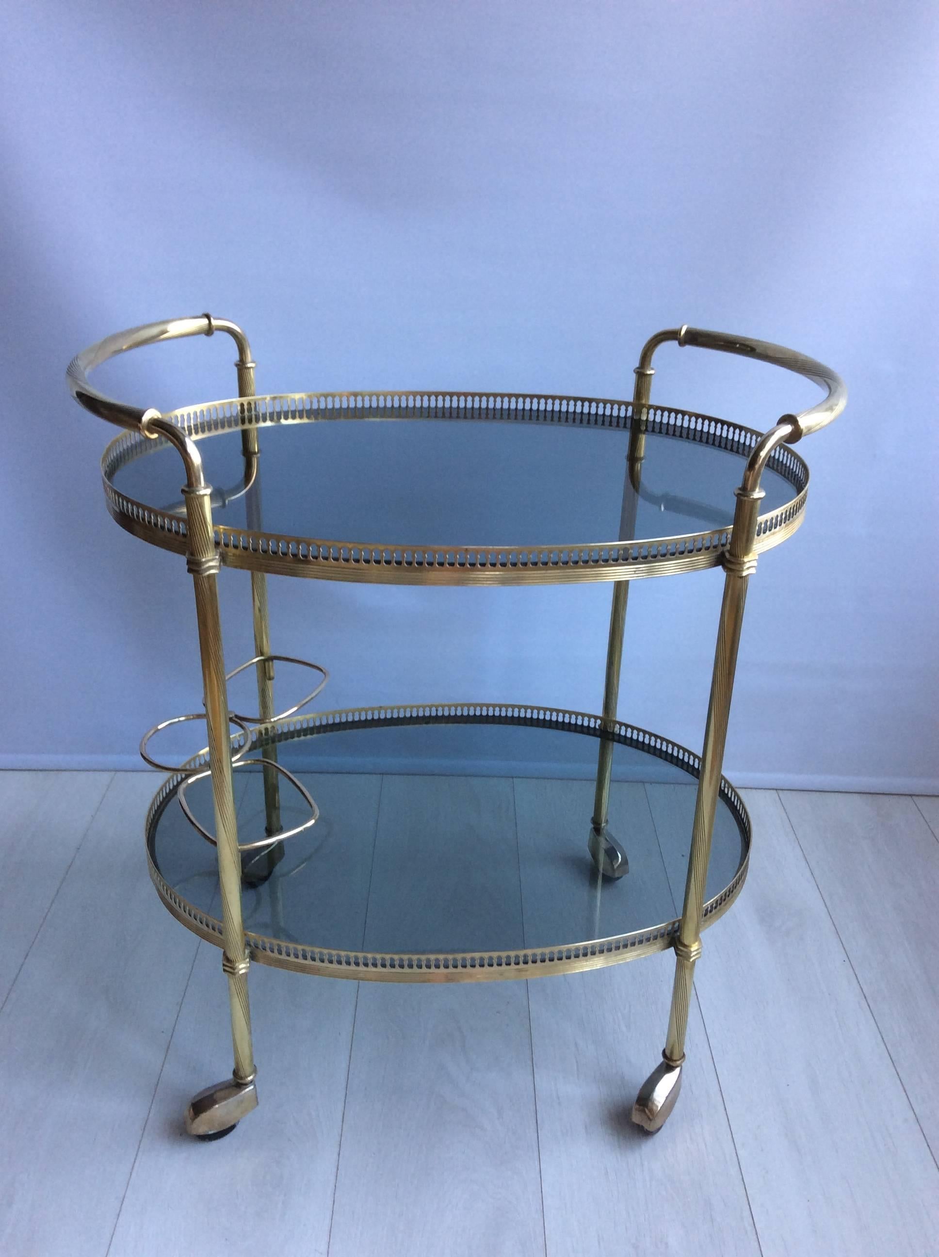 Lovely detailing to this vintage French drinks trolley, circa 1970.

Smoked glass shelves and bottle holder to lower tier

Top tray measures 63.5cm wide, 45cm deep with glass 61.5cm tall.
Overall 67cm wide, 45cm deep and 71.5cm tall.