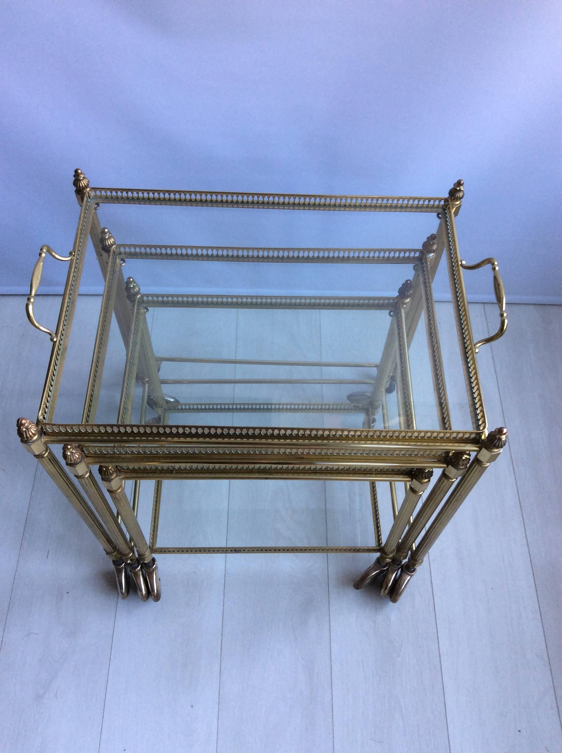 A nest of three French brass drinks trolleys or bar carts with removable tops, circa 1950.

Largest trolley measures 59cm wide, 41cm deep and 62cm tall.
Middle 50cm wide, 36.5cm deep.
Small 43.5cm wide, 31.5cm deep.