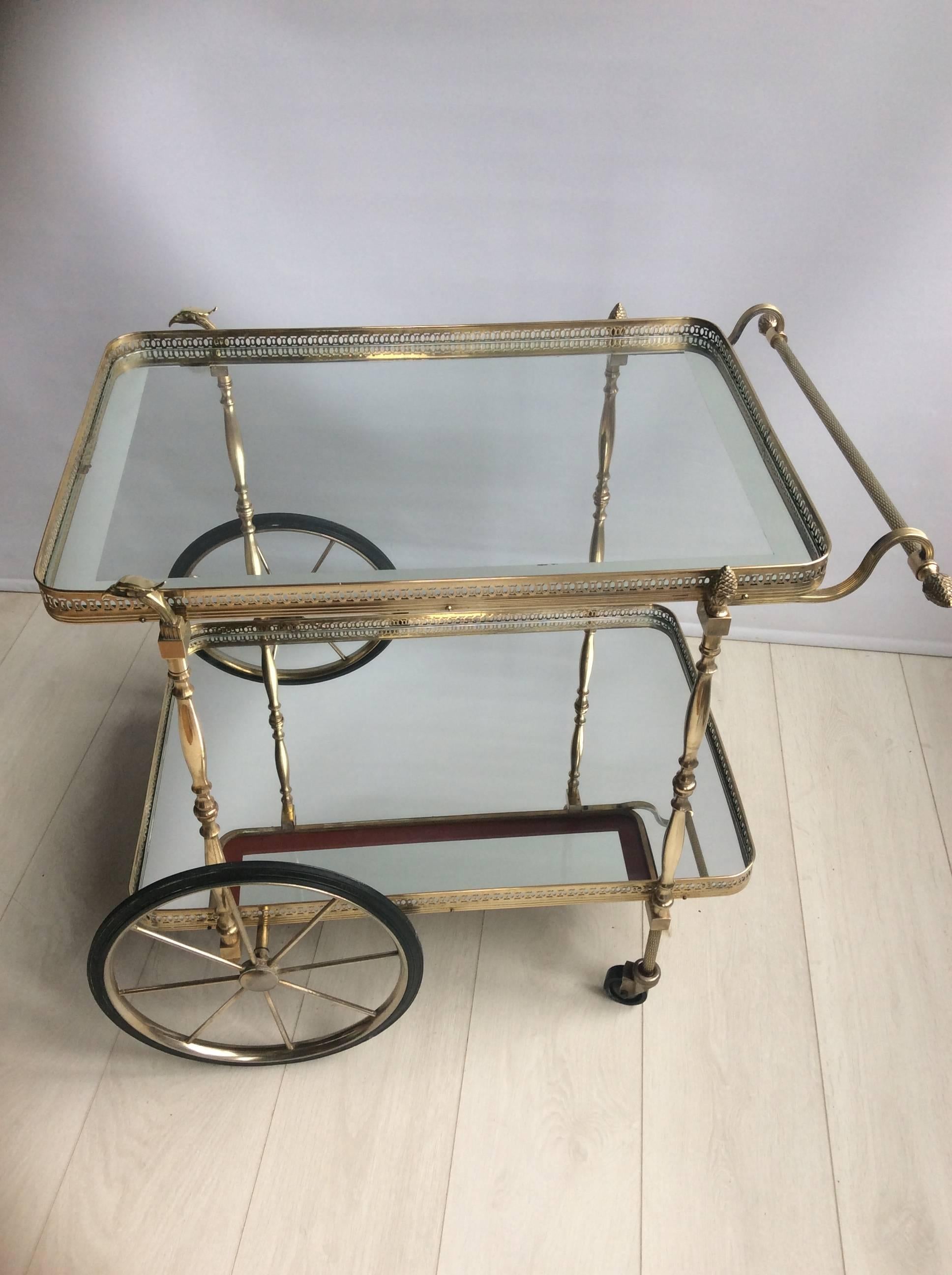 Highly decorative drinks trolley from France, circa 1950

with mirrored lower shelf

Top tray measures 66.5 cm wide, 46 cm deep and stands 59.5 cm to glass
Overall dimensions 80 cm wide, 60 cm deep and 62 cm tall.
