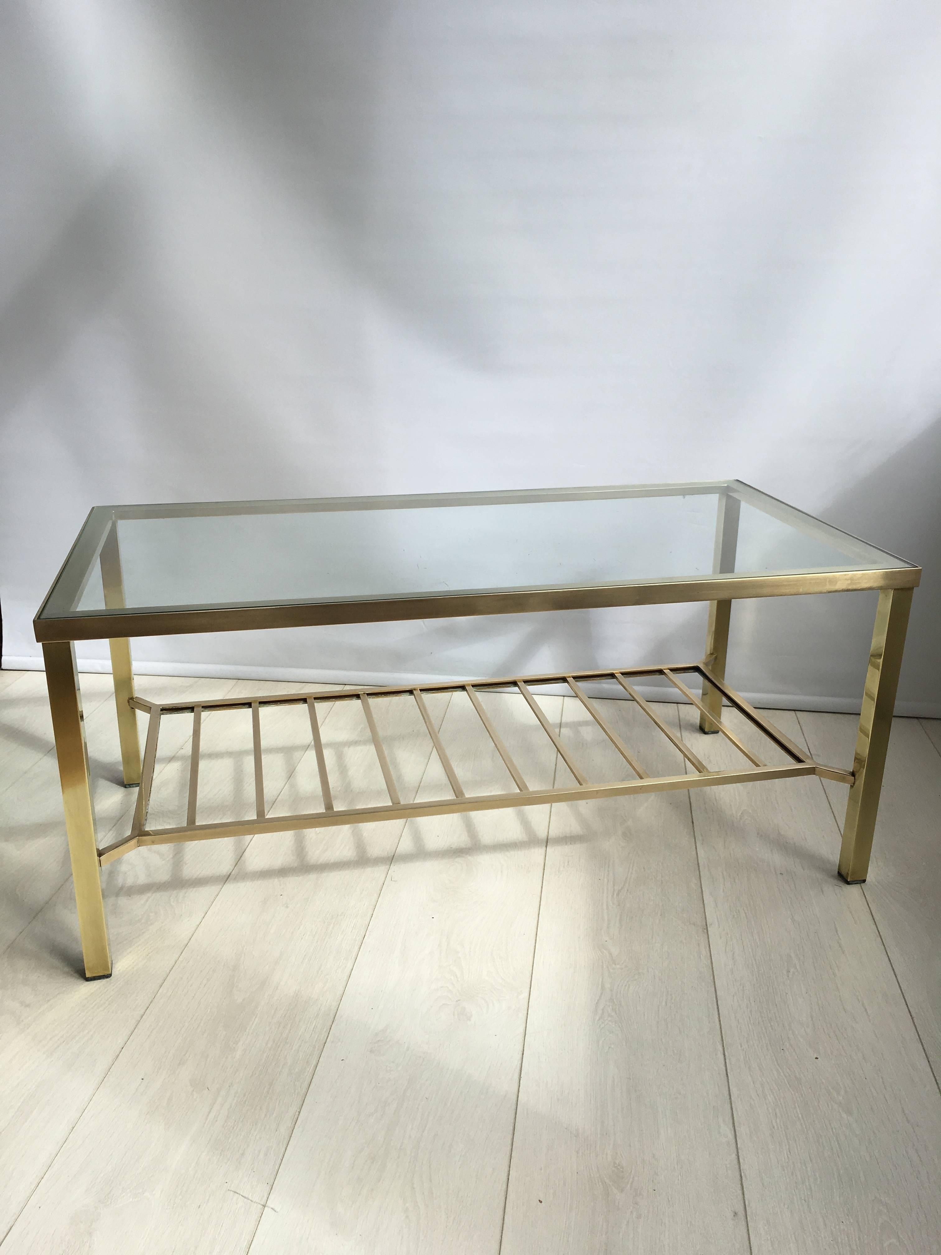 Polished brass coffee table with useful shelf underneath, circa 1970

Measuring 92cm wide, 46.5cm deep and 40.5cm tall.
