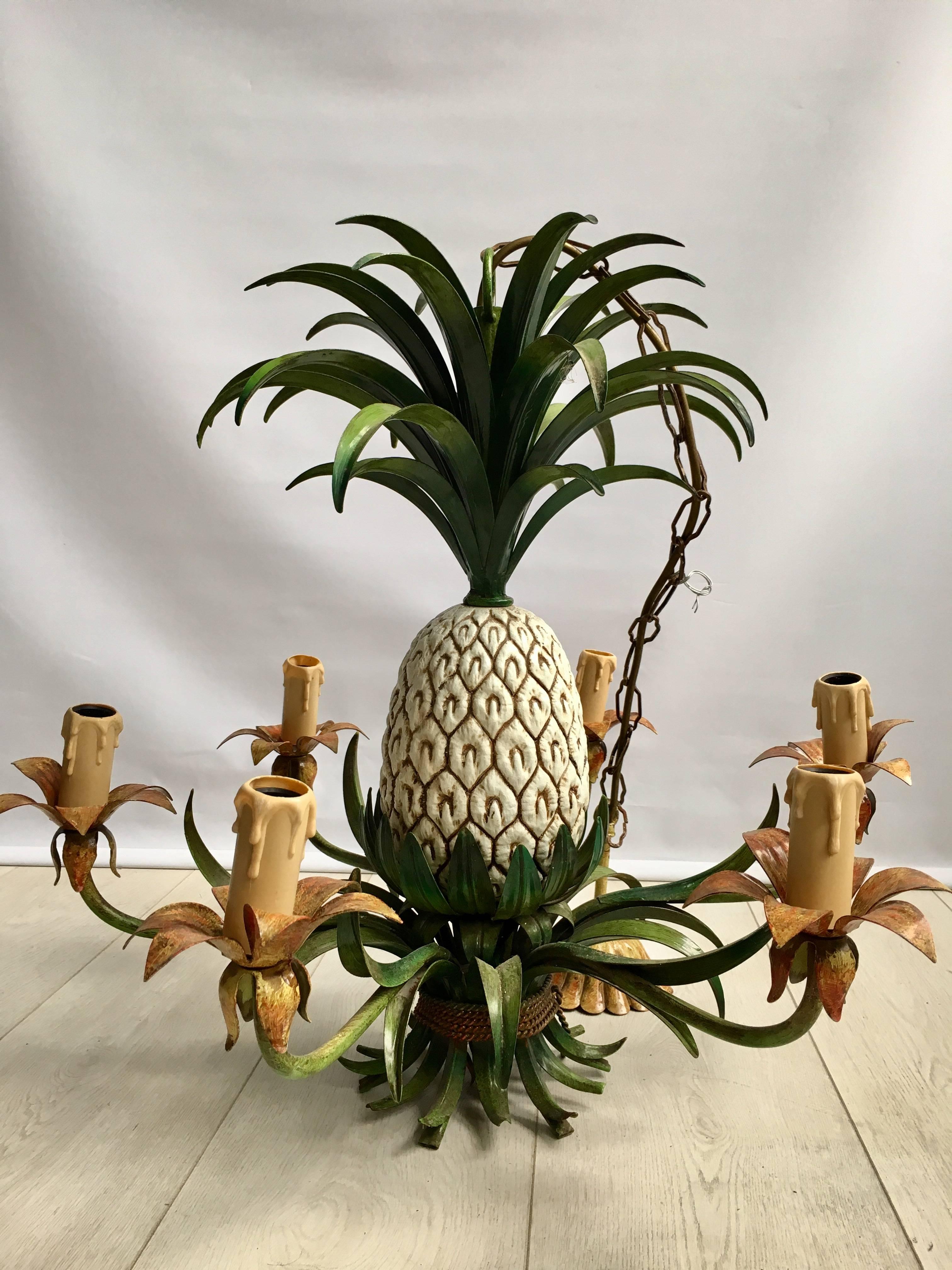 Quite unique pineapple chandelier from France, circa 1960

Lovely vibrant green color to the painted tole leaves, a large pineapple sits at the centre of the chandelier with six arms.

Measuring: 54cm tall (with additional 50cm of chain) and