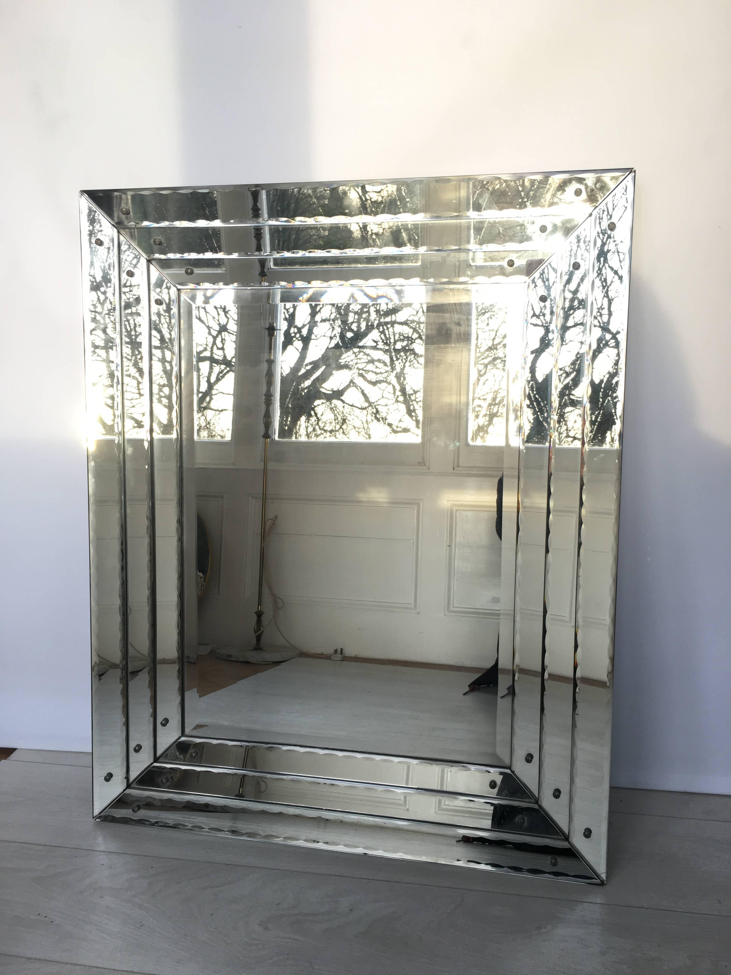 Truly stunning mirror with triple banded mirror frame. 
Each band has a scalloped edge which gives the most amazing reflection.
Some minor aging to the glass border mirror consistent with age - please see close up images. 
No chips or cracks.