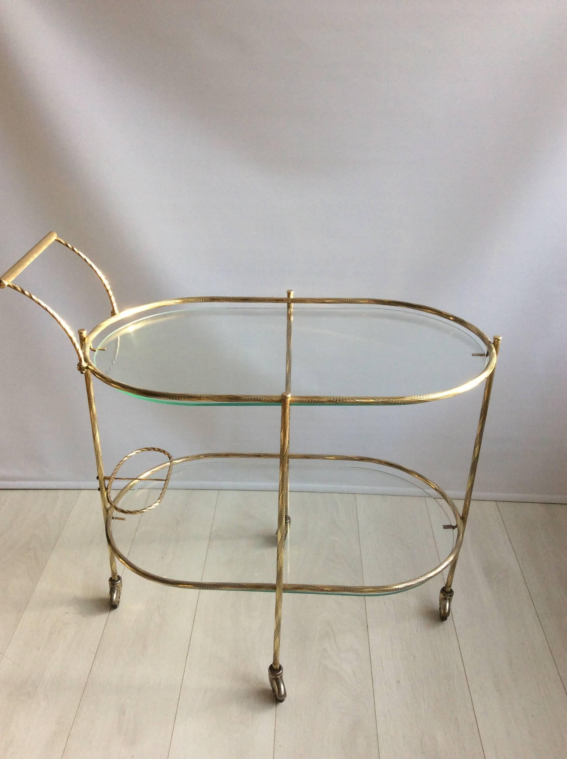 Delicate framework and detailing to this French drinks trolley, circa 1950.

Top glass measures: 71cm wide, 40.5cm deep and stands 65cm tall
Overall diameter 85cm wide, 47cm deep and 82cm tall.