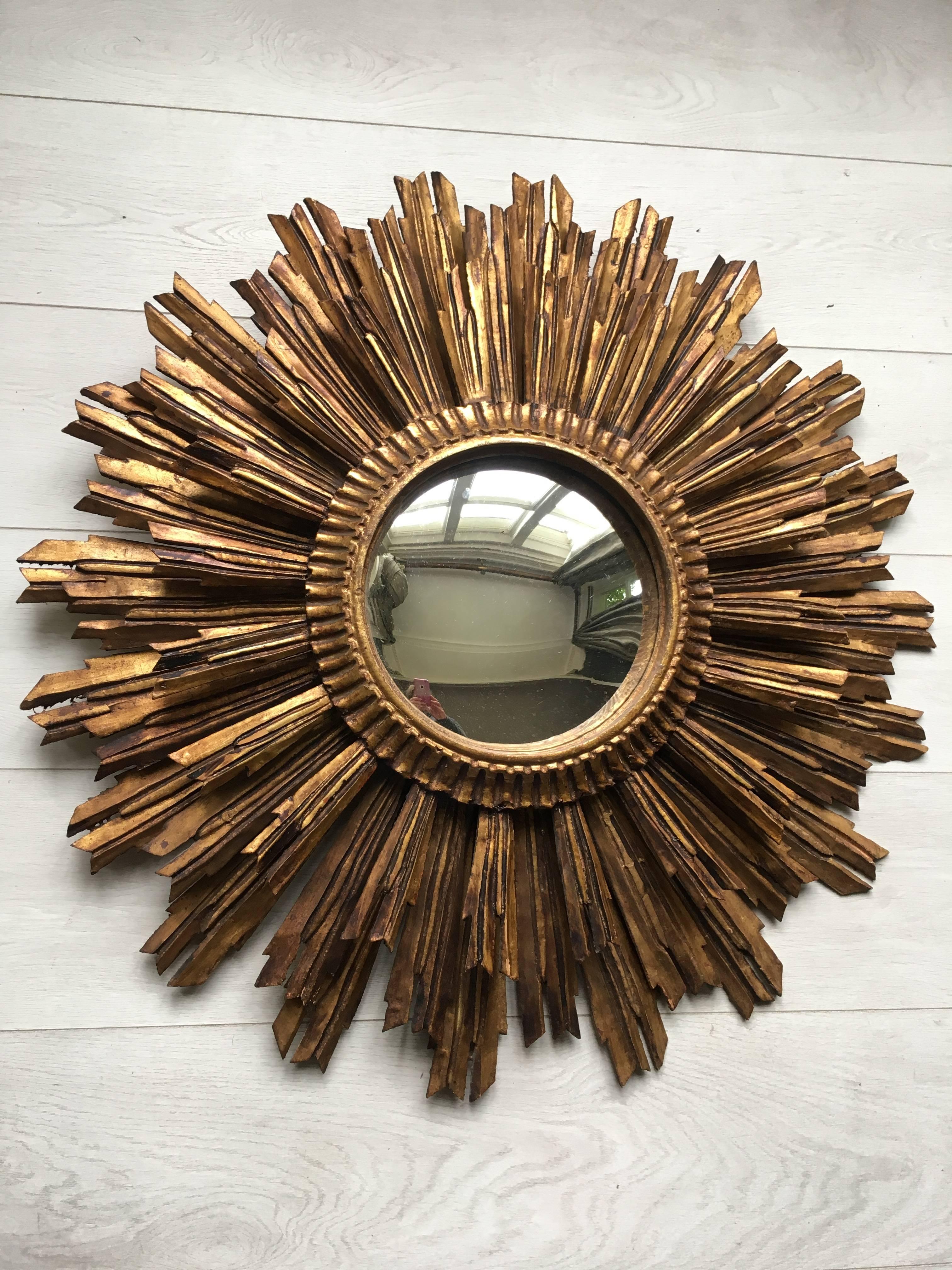 Truly beautiful, 1950s French carved giltwood Sunburst mirror 

With three layers of rays and measuring 77 cm across this will make a statement.
     