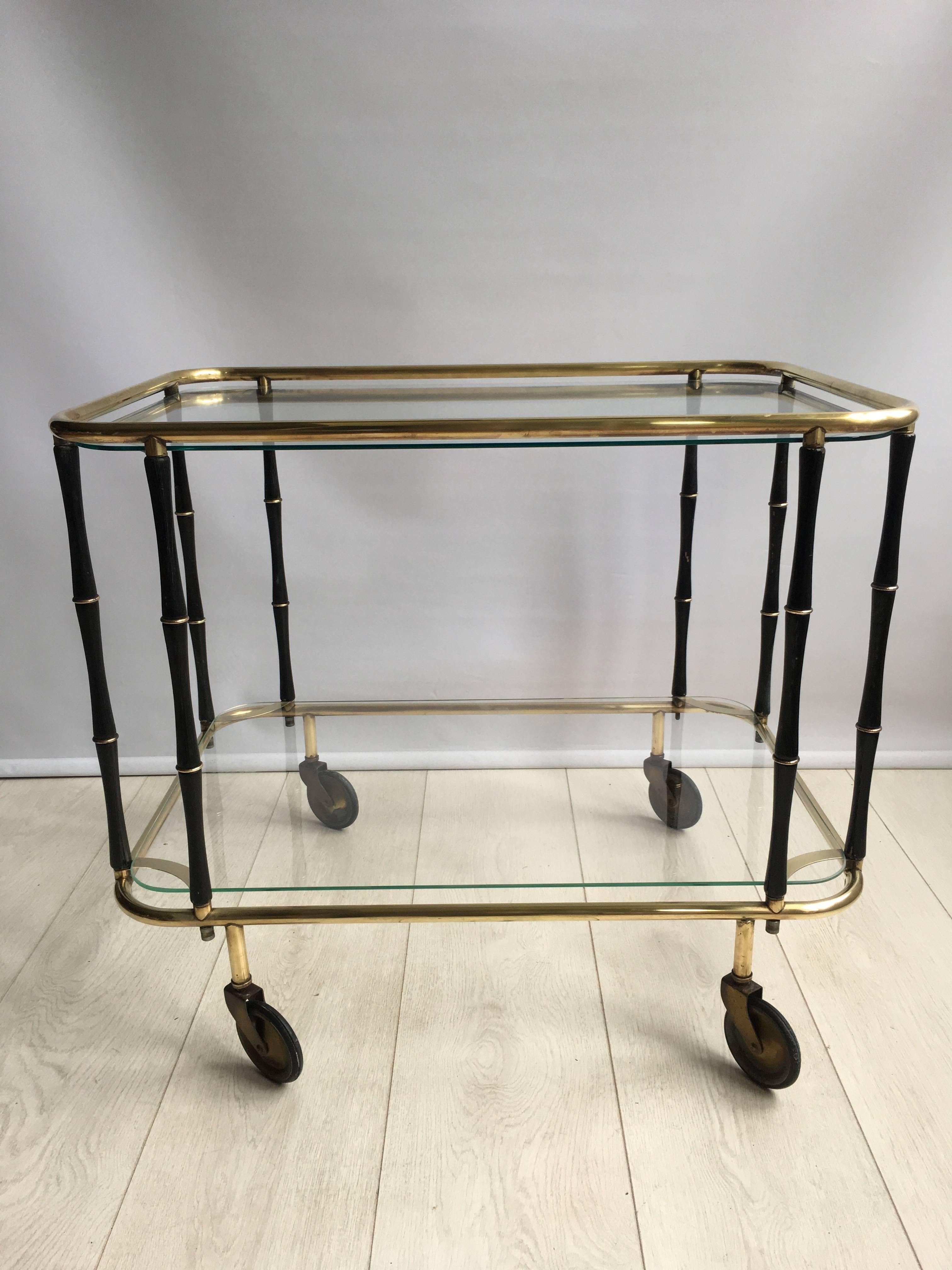 Midcentury drinks trolley from France, circa 1960

Ebonized bamboo legs on a brass frame.

Measuring 66.5cm wide by 45cm deep and 56.5cm tall.