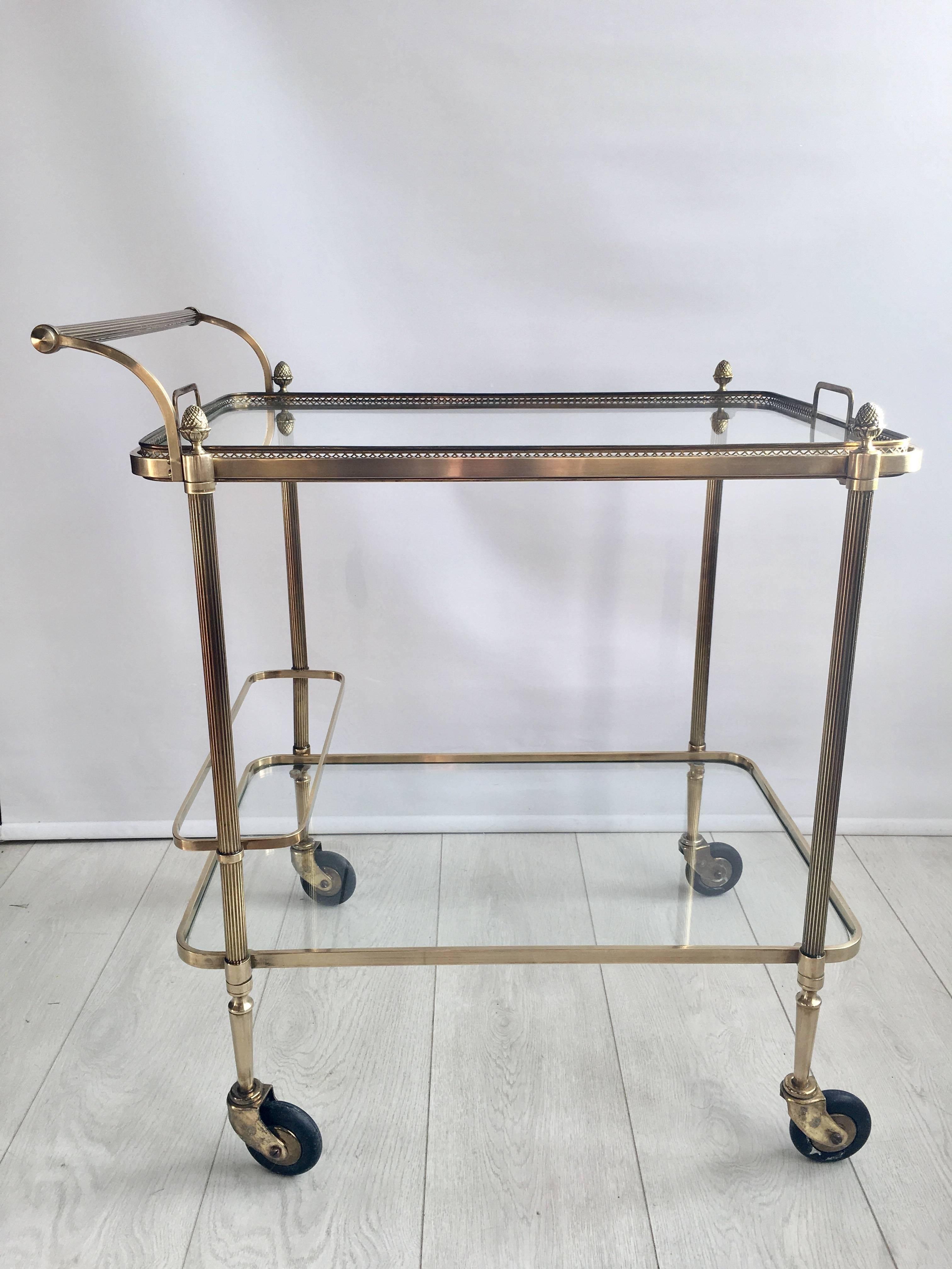 Lovely clean lines and quality to this vintage French drinks trolley in the style of Maison Baguès

Polished brass frame with lift off top tray and bottle holder to the lower tier

Top tray measures 60cm wide by 44cm deep and stands 64cm to