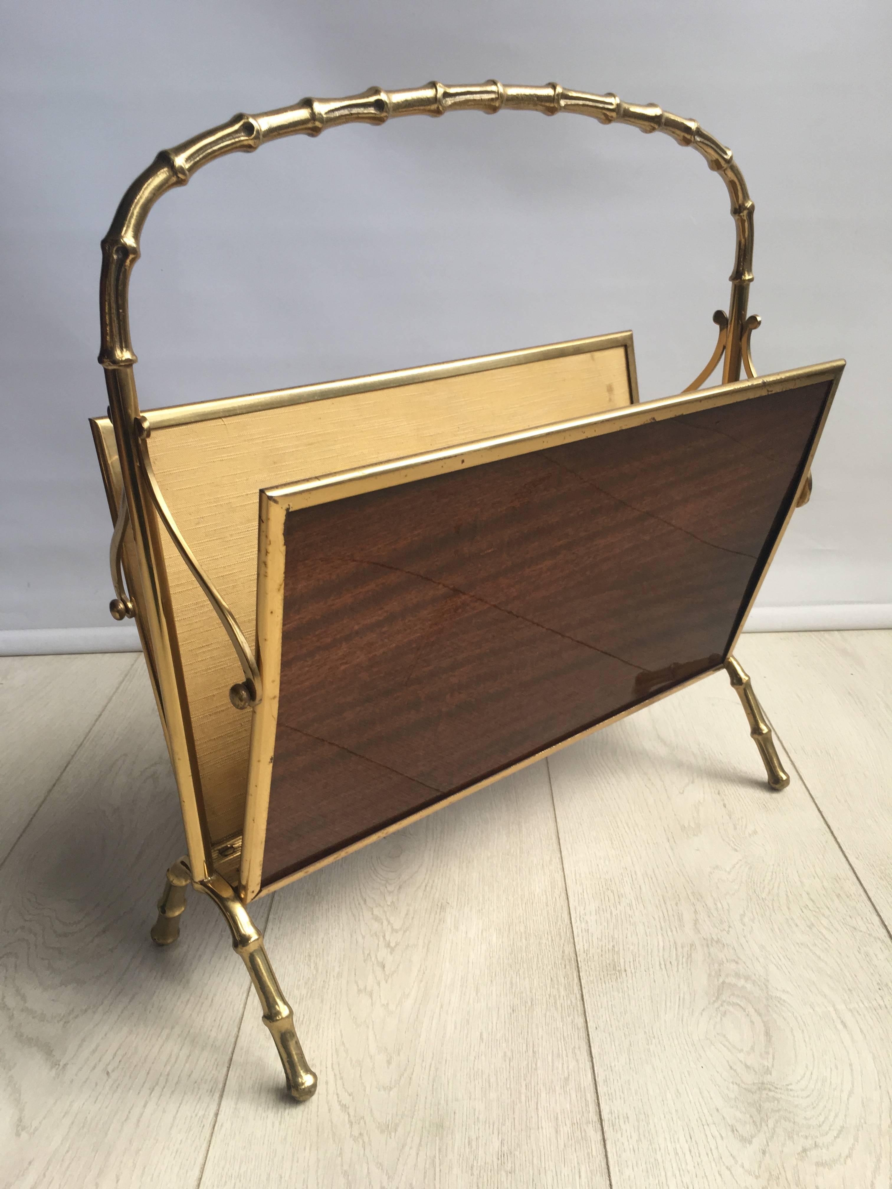 A quality brass magazine rack attributed to Maison Bagues, Paris, circa 1960.

Faux bamboo brass frame, material lined inside.

Reassuringly heavy and great looking 

One scorch mark bottom centre as per close up images, 

France, circa