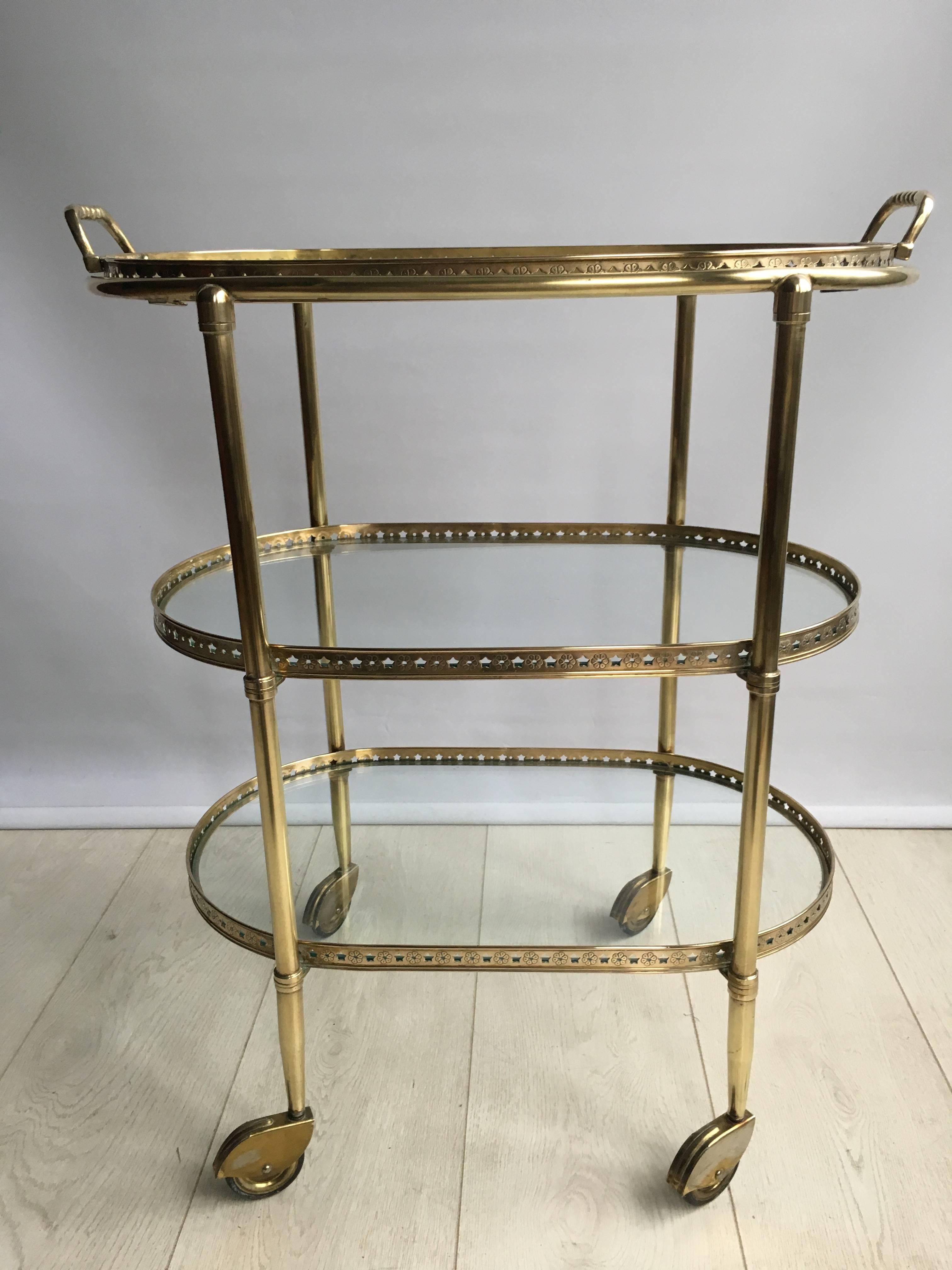 Attractive brass drinks trolley from France c1950

Star detailing to the lift off tray

Top tray measures 51cm wide, 30.5cm deep and stands 63cm tall 