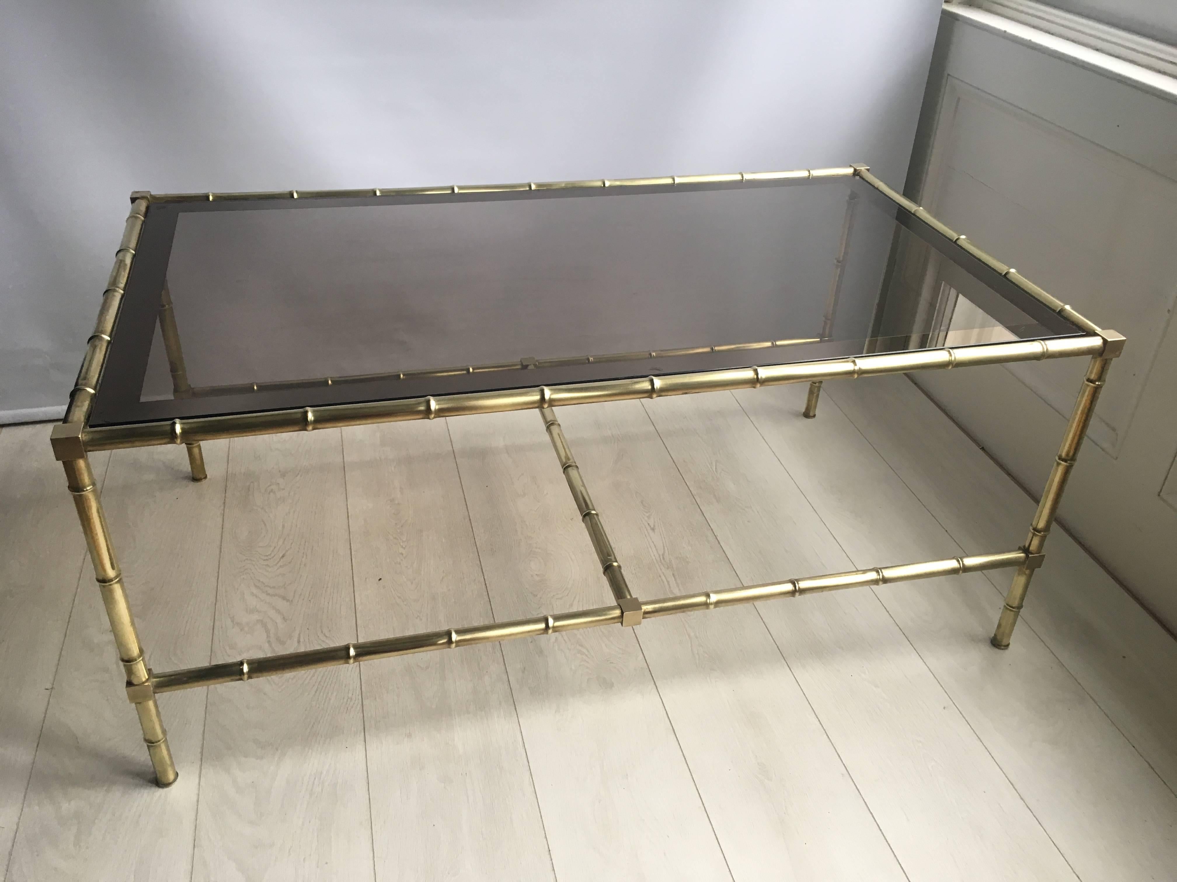 Fantastic faux bamboo coffee table from France, circa 1970

Polished brass frame with original tinted glass top

Great size at 115.5cm by 65.5cm and stands 50cm tall.