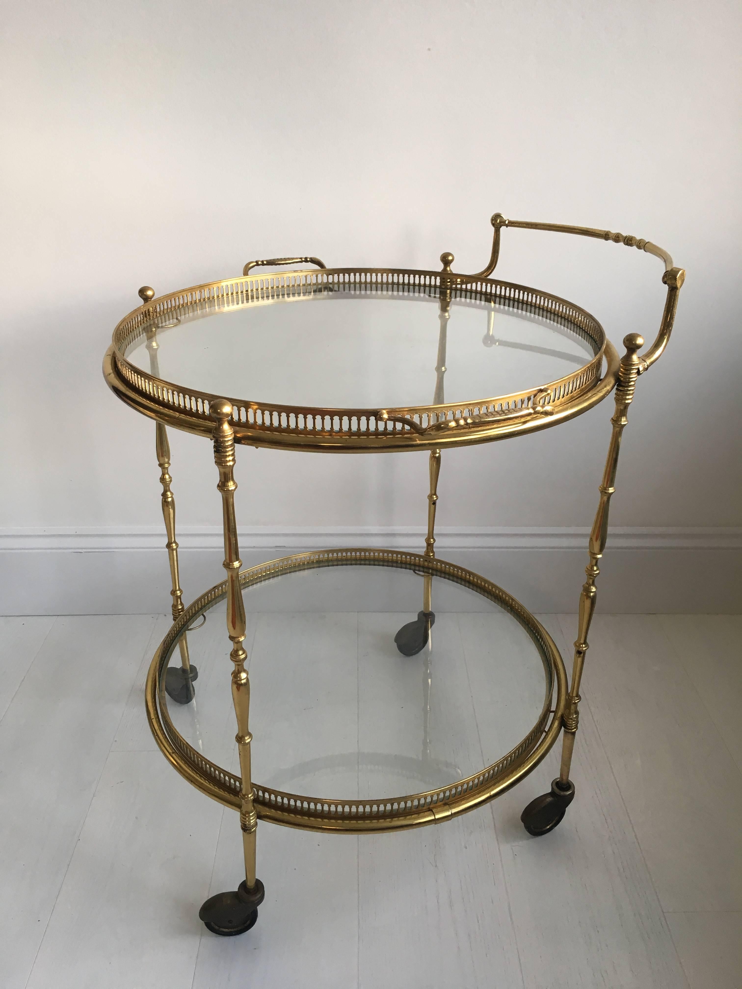 Generous in size, this beautiful circular French drinks trolley, circa 1950

Lacquered brass frame with aged patina (can be polished back if required)

Lift off top tray measuring 51.5cm across (62cm with handles).

         