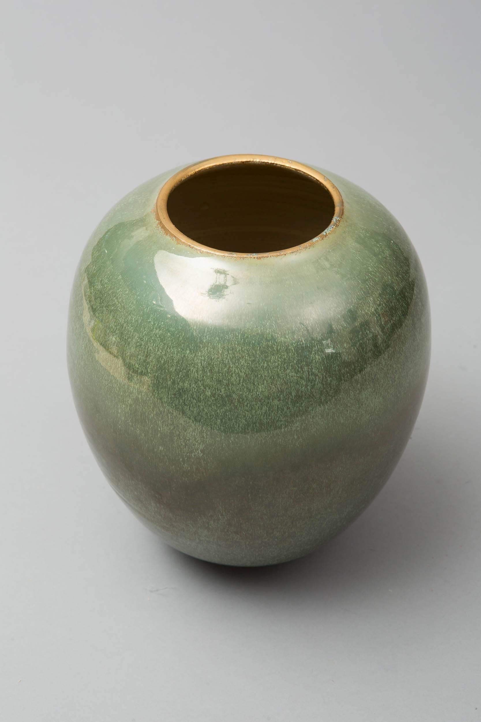 Wheel thrown white stoneware vase. 
Green celadon.
Glazed and gilted. 
One of a kind signed on the bottom. 
