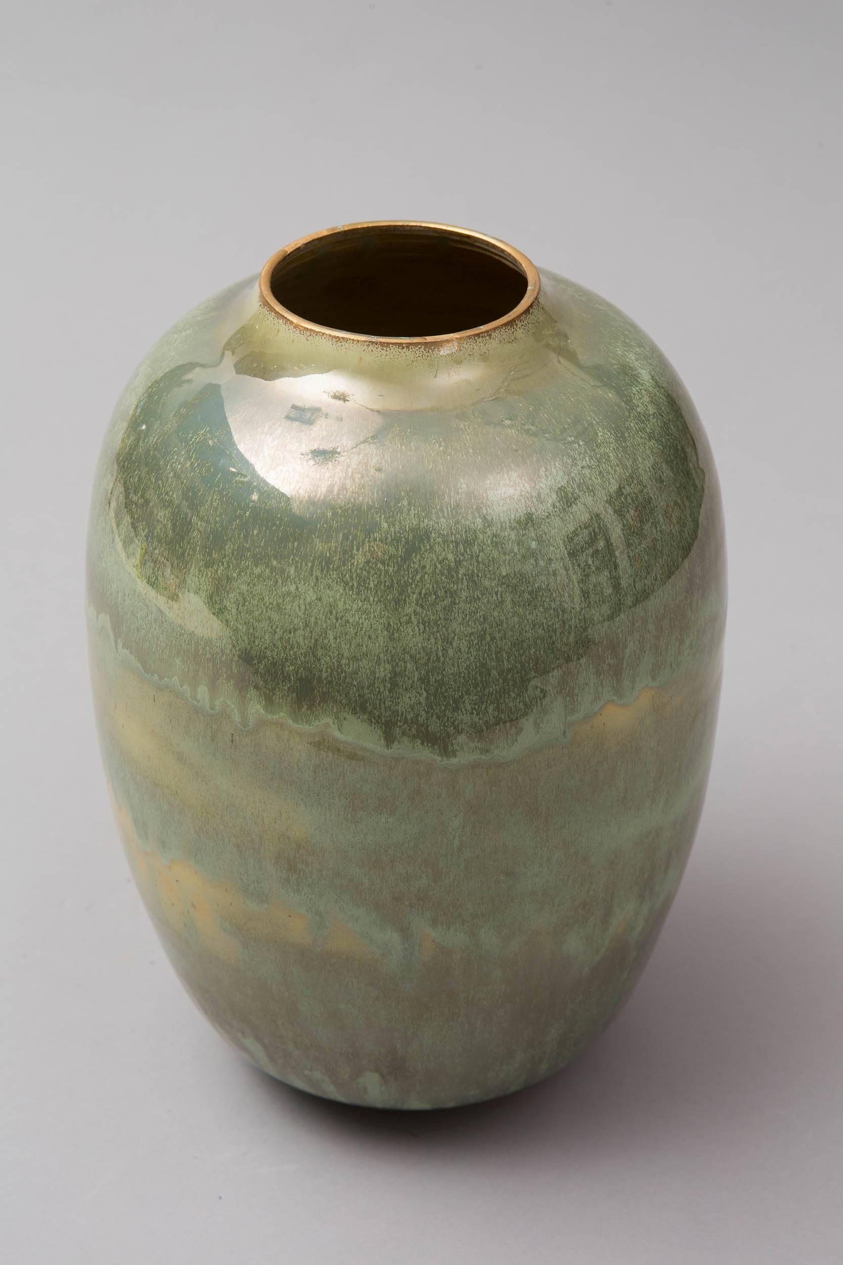 Wheel thrown white stoneware vase.
Green celadon.
Glazed and gilded.
One of a kind signed on the bottom.
