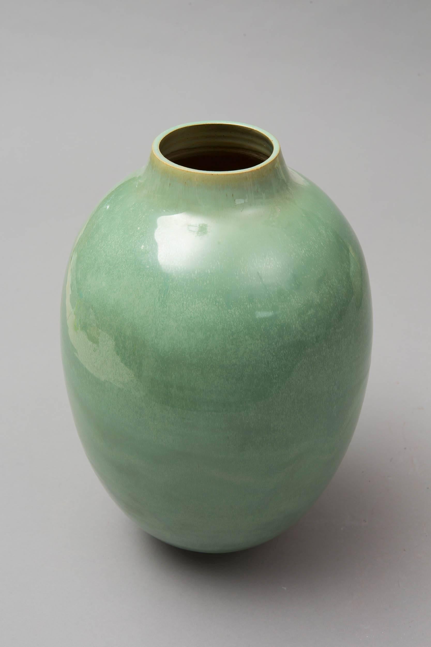 Wheel thrown ceramic green celadon vase.
White stoneware glazed. 
One of a kind.
Signed on the bottom. 