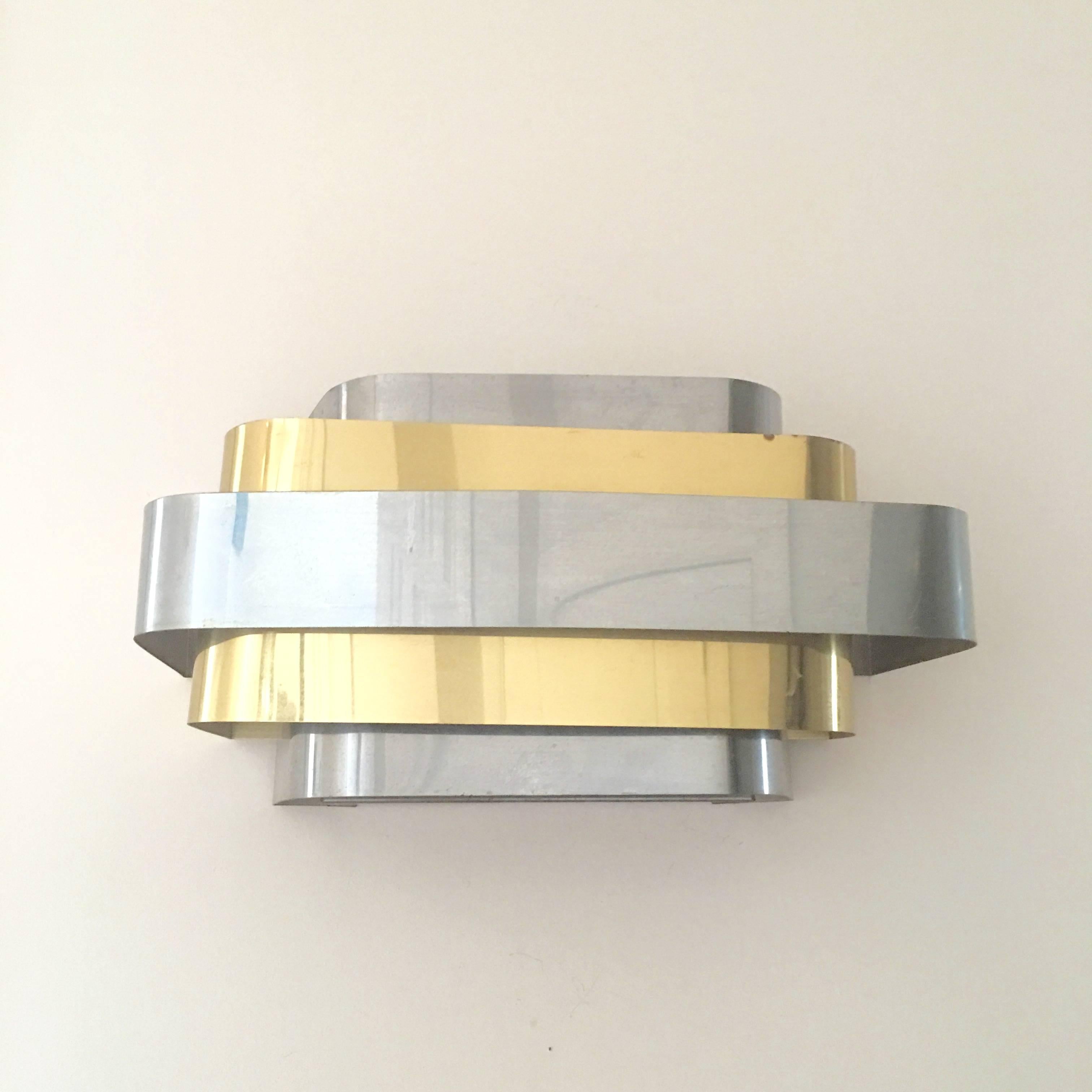 Substantial and fabulous pair of brass and chrome sconces in the style of Paul Evans for Lightolier. The design is a Classic Art Deco style probably made in the 1970s and quite stunning.
 