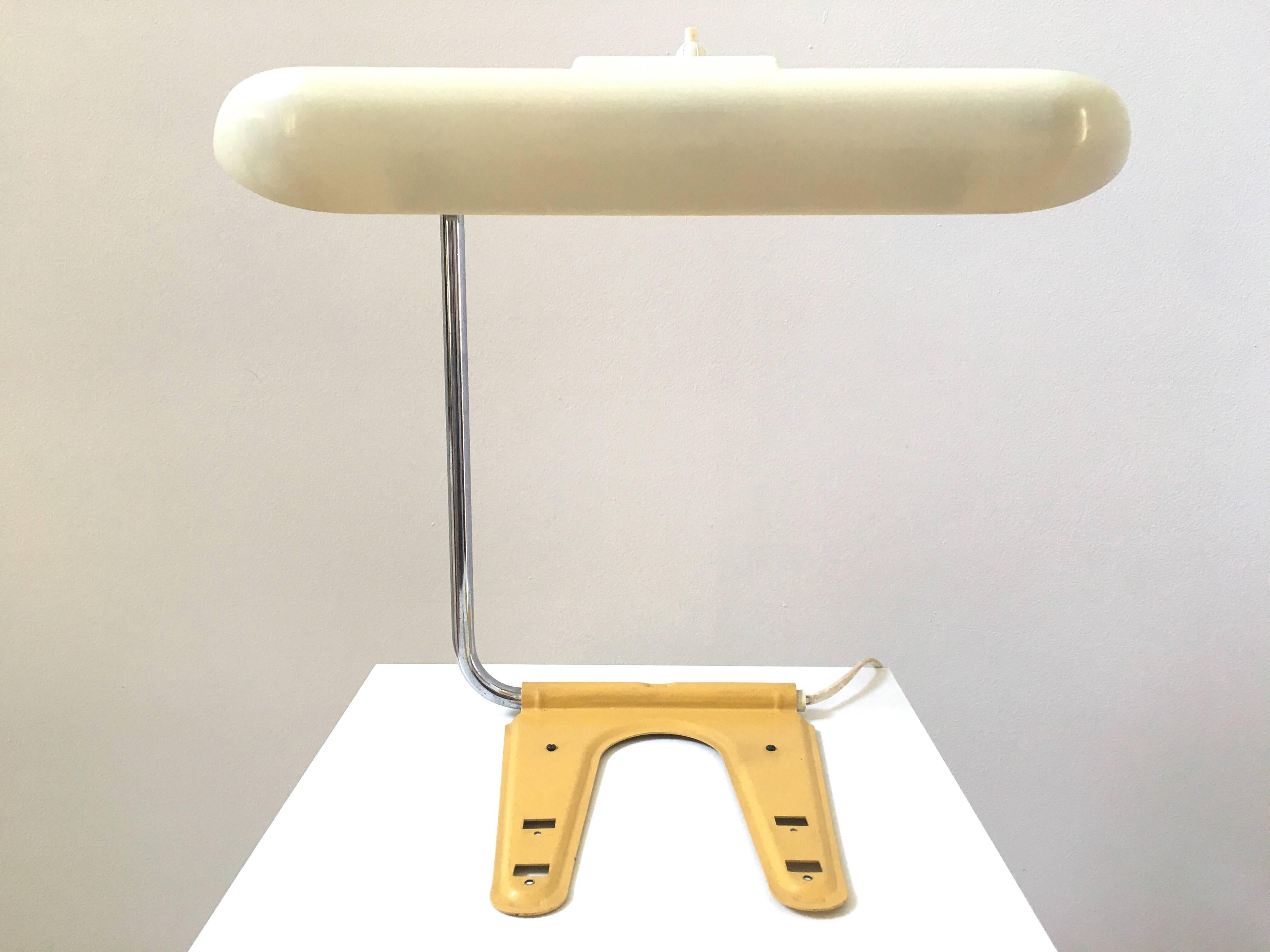 A French desk lamp in the style of Charlotte Perriand. Conceived to take very minimal space, the head of the lamp is adjustable.