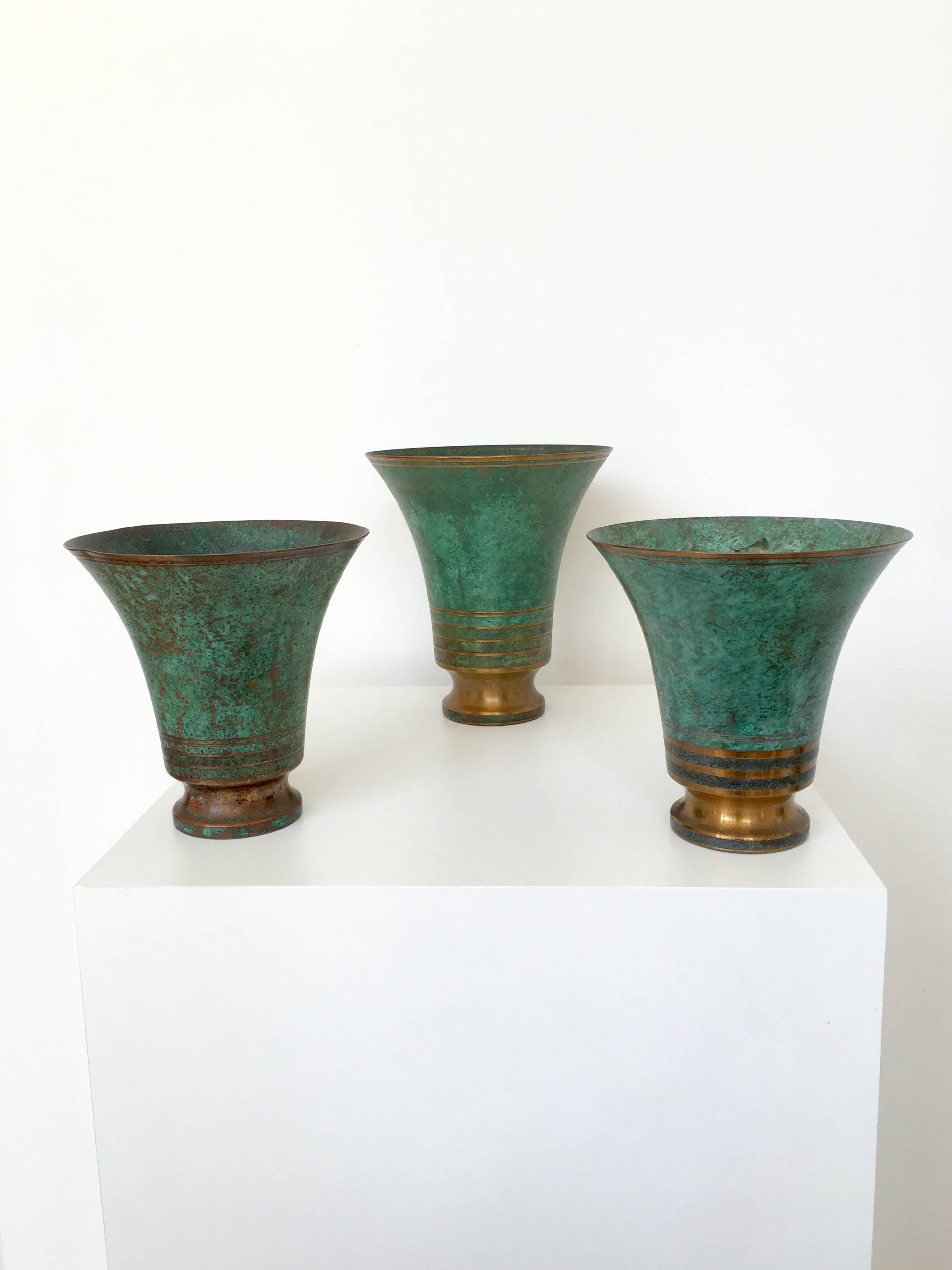 With their gorgeous verdigris patina, these bronze vases by Carl Sorensen are optimal in their size and form creating a striking collection. All three vases have the 