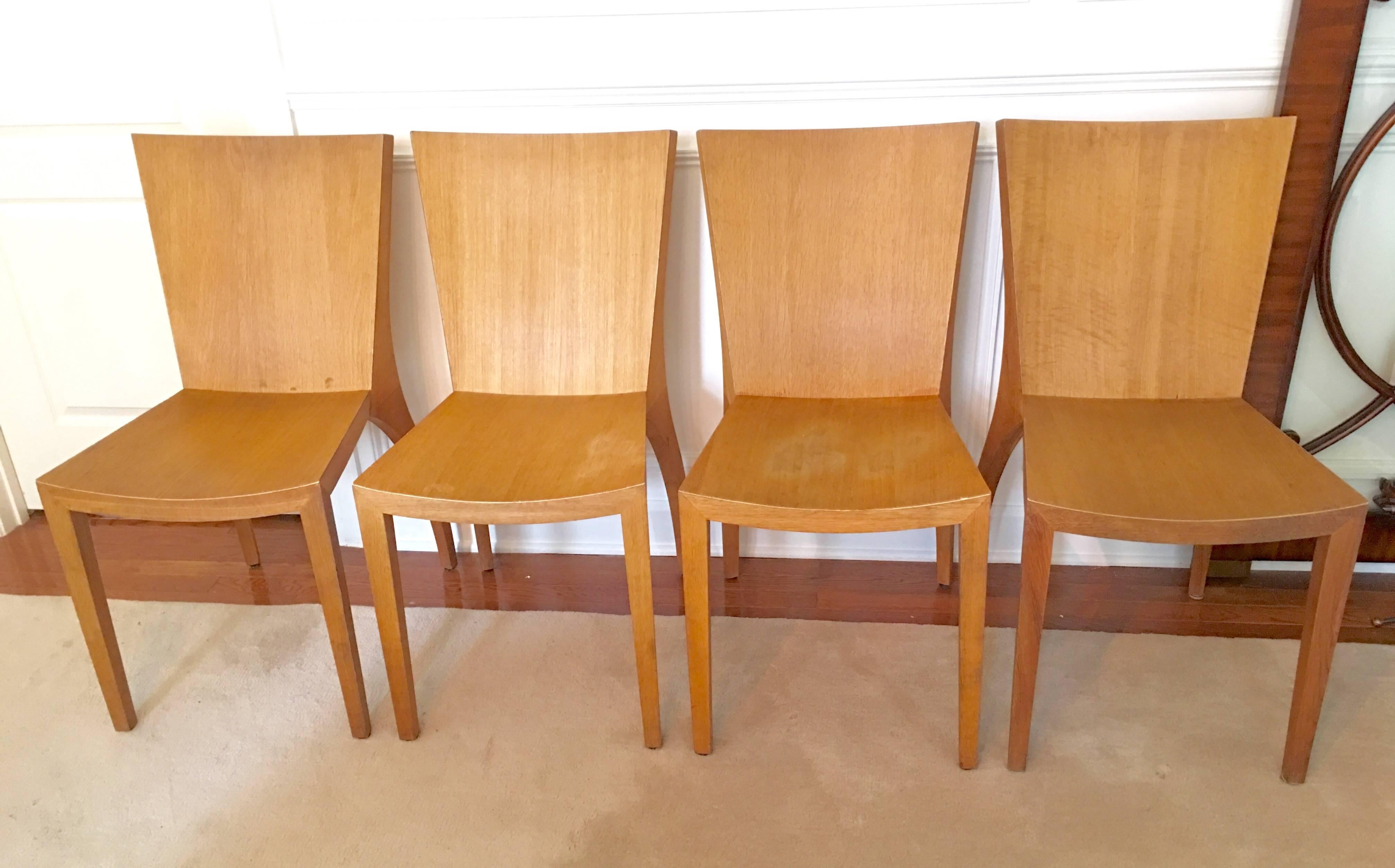 Very stylish set of four oak dining chairs in the style Jean-Michel Frank from the 1940s. The pair of hind legs on these chairs look like they are ready to prance. Gorgeous shape. They look fabulous with fur seat cushions.