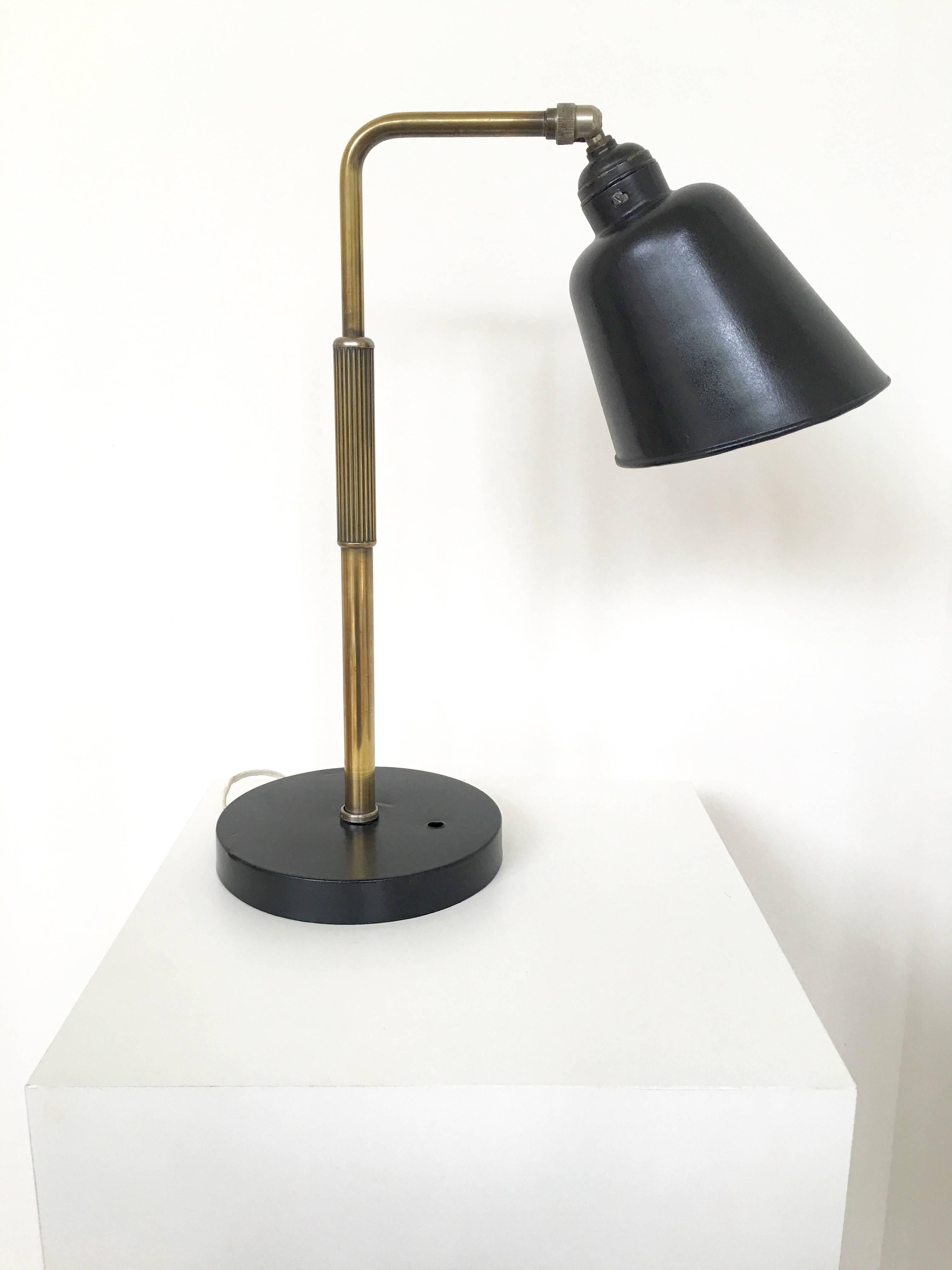 A classic Bauhaus style metal lamp with a black painted shade and base. Has a lovely Industrial quality to it much like those of Christian Dell.