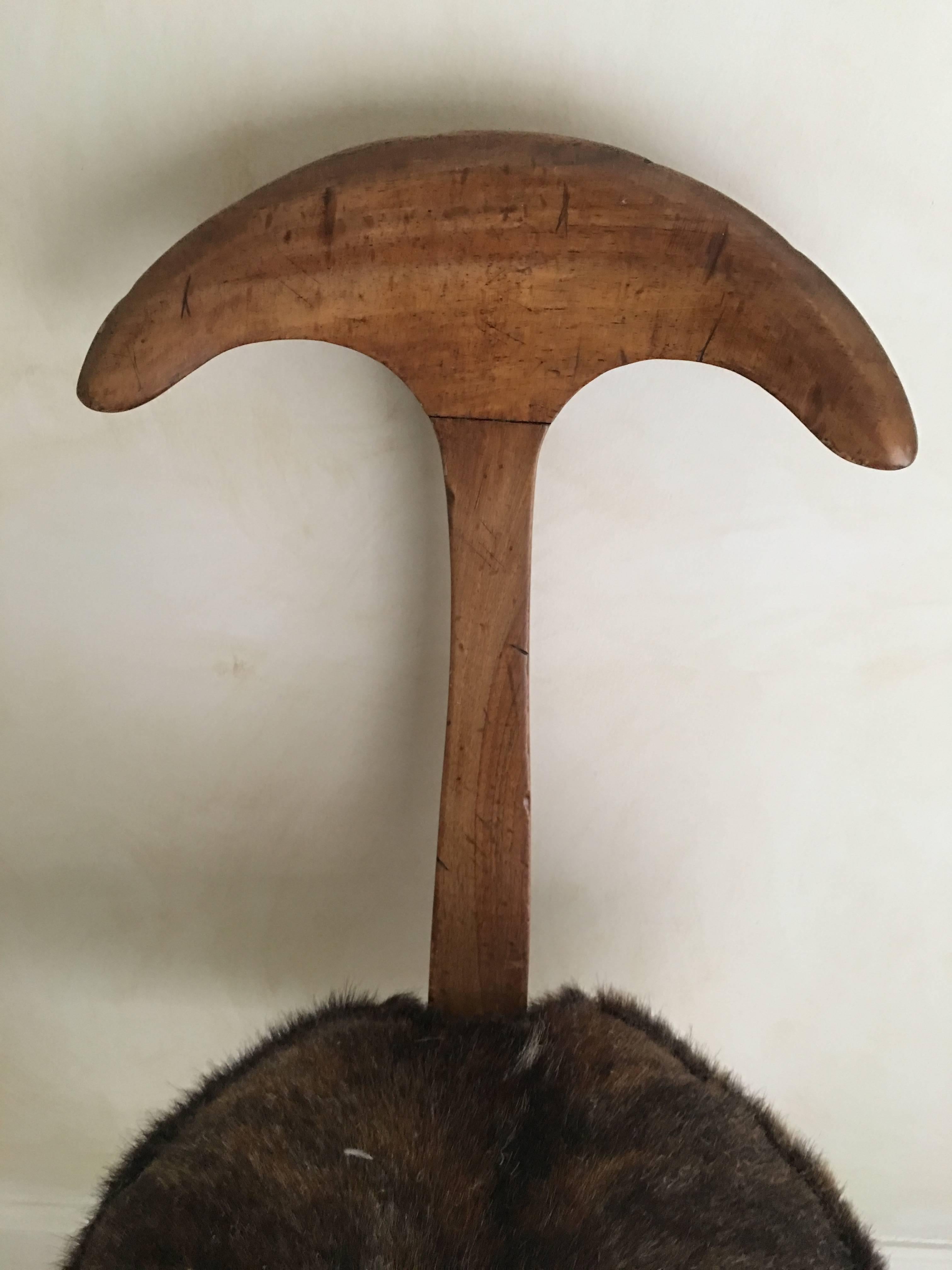 A very rare and unique piece, this tri-leg decorative chair is very much in the style of Gio Ponti and is from Italy. A fabulous accent piece. Could be used as a hall chair or a stool. Made of walnut that shows natural marks and cow hide seat edged