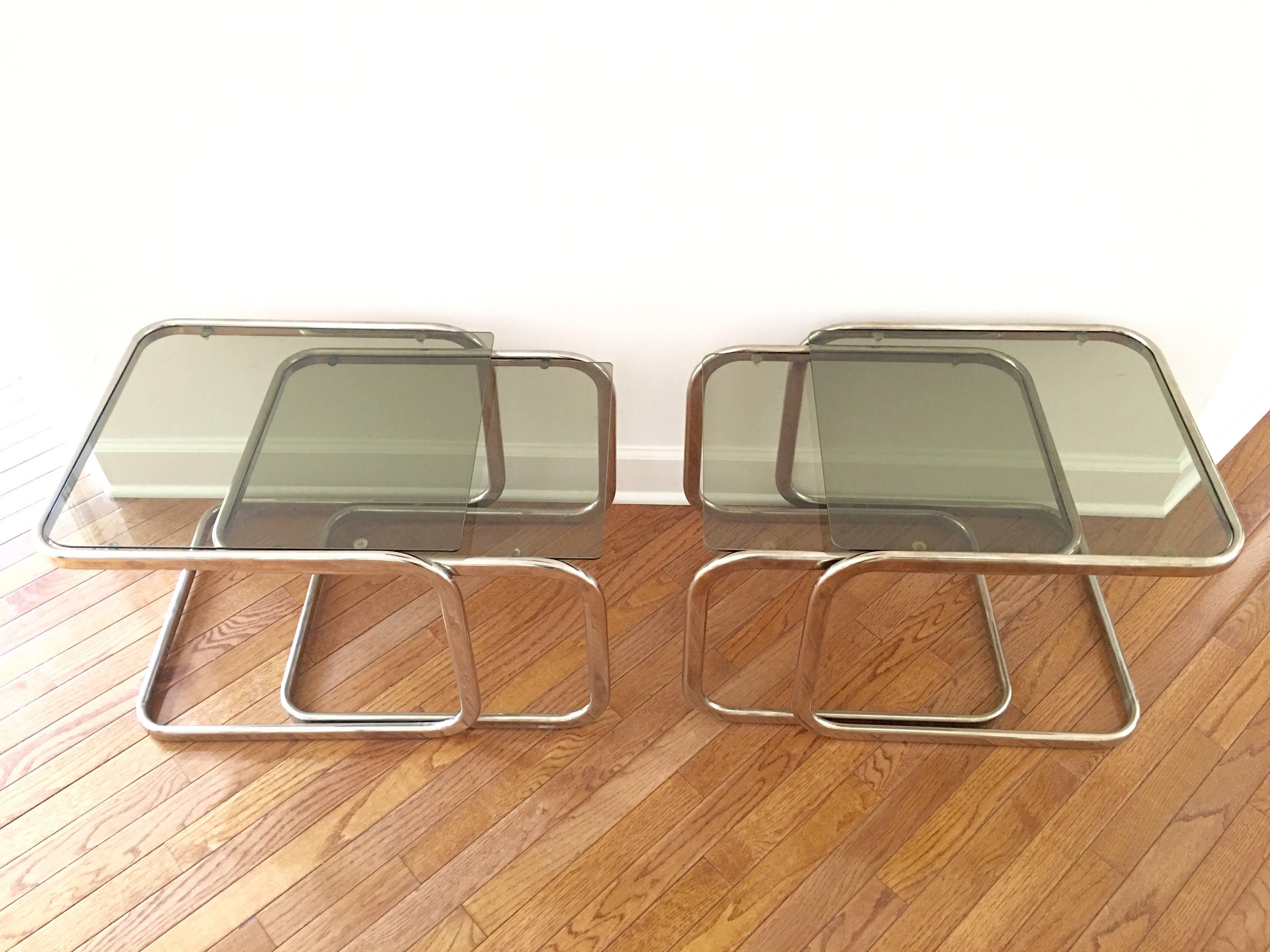 An elegant pair of brass and glass nesting tables with an unmistakable mid-century styling. Each set contains two tables for a total of four. Slight variations in the size of each table as given below.

Dimensions for other three tables:
Table 2:
