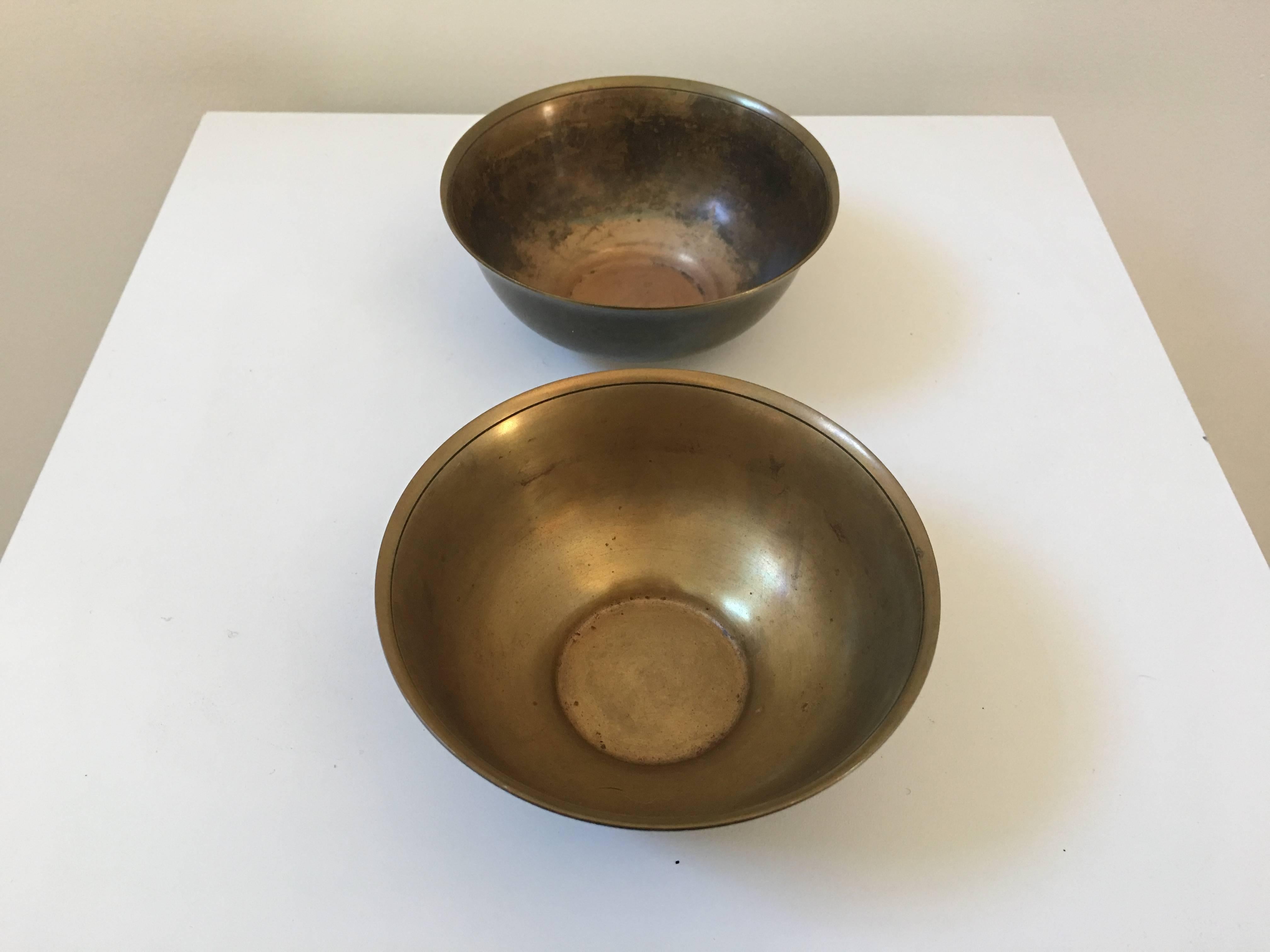 A fabulous pair of bronze bowls with the most perfect shape to cradle in one's hands. The patina is wonderful too. Signed at the bottom.
