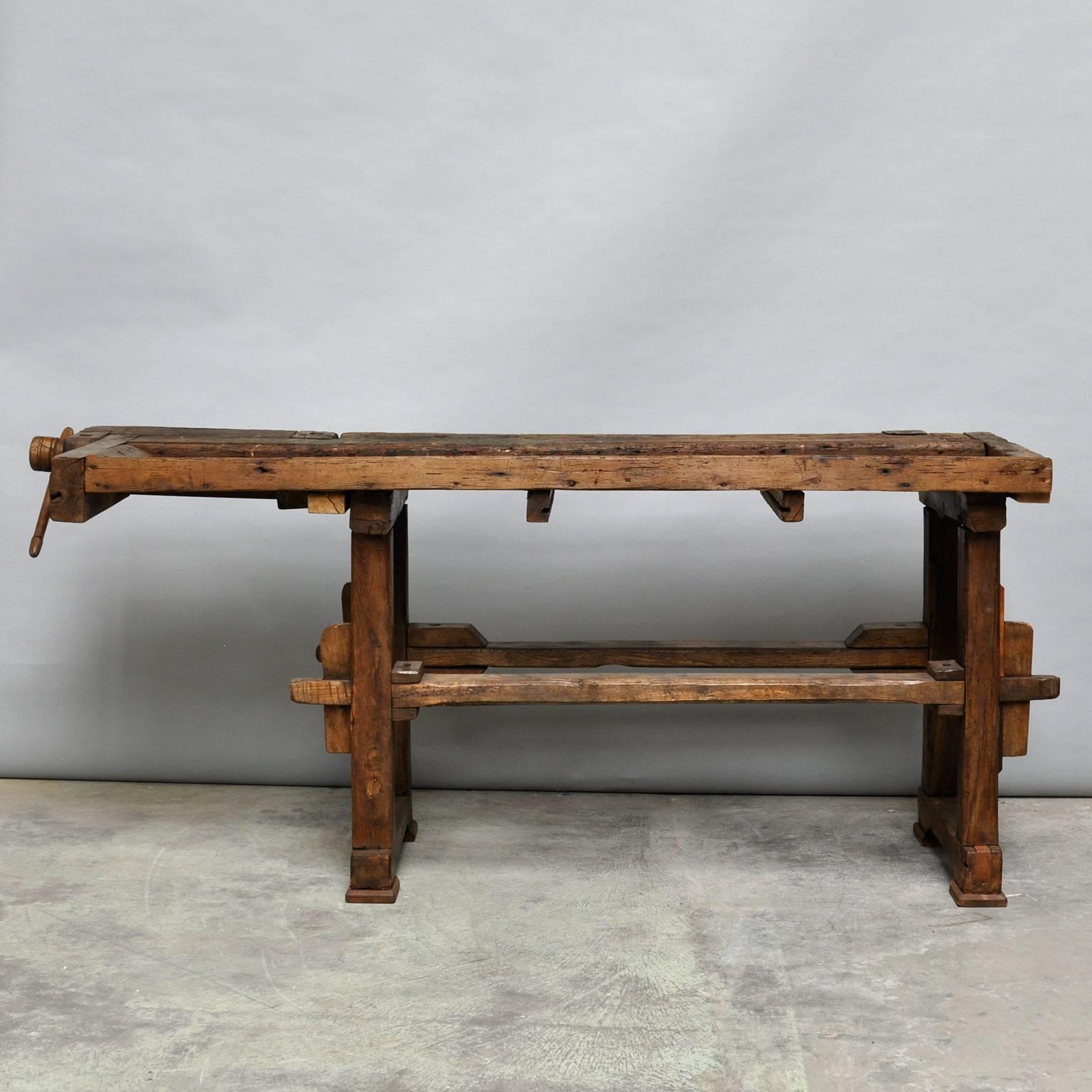 Antique Hungarian carpenters’ workbench, bearing a very nice patina after years of use. It has one vice with a wooden handle and a recessed tray where the carpenter would lay his tools. It has been restored and waxed.