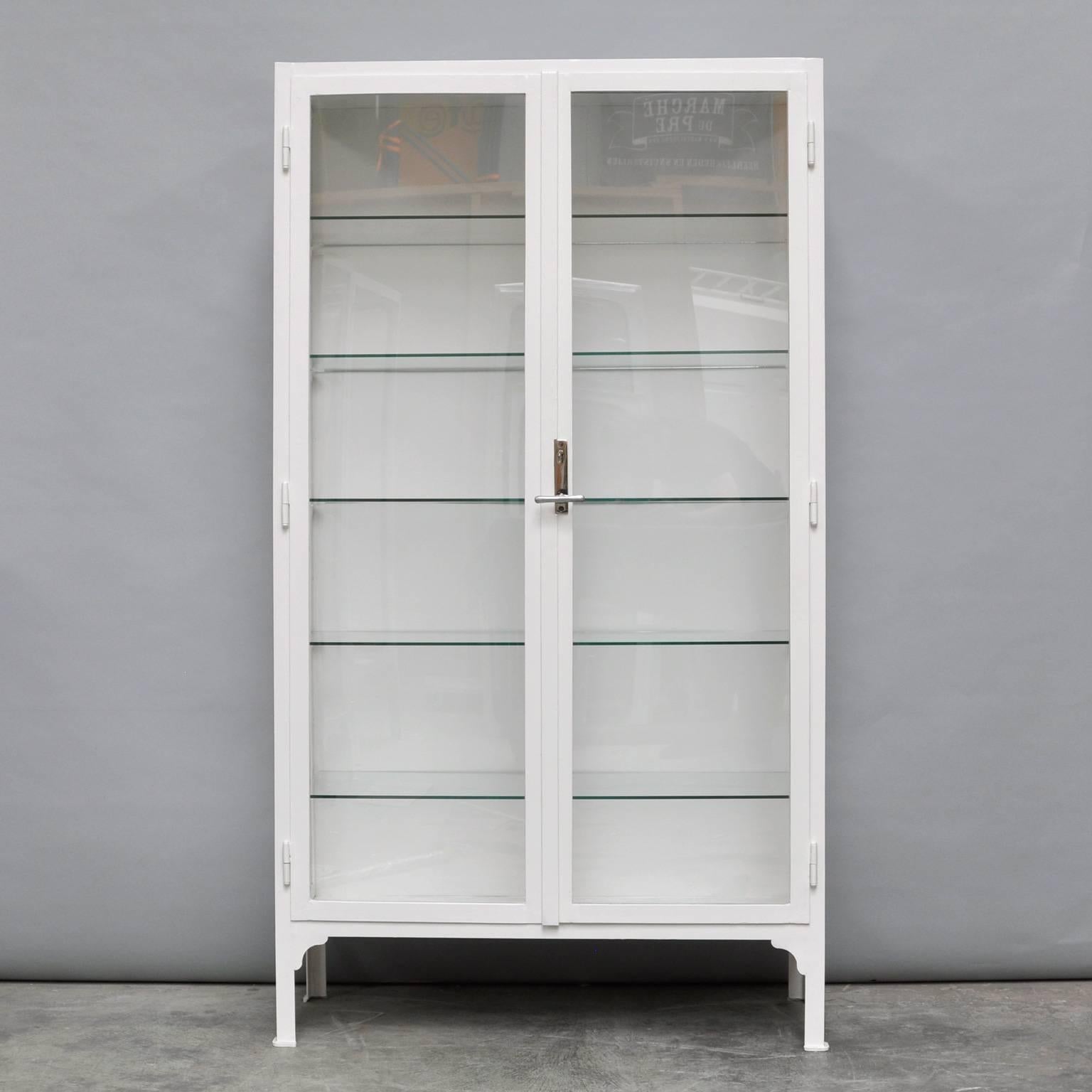 This medicine cabinet was produced in the 1940s in Hungary. The cabinet is made from thick steel and glass. It features five (new) glass shelves. In an excellent condition. The cabinet has been restored.