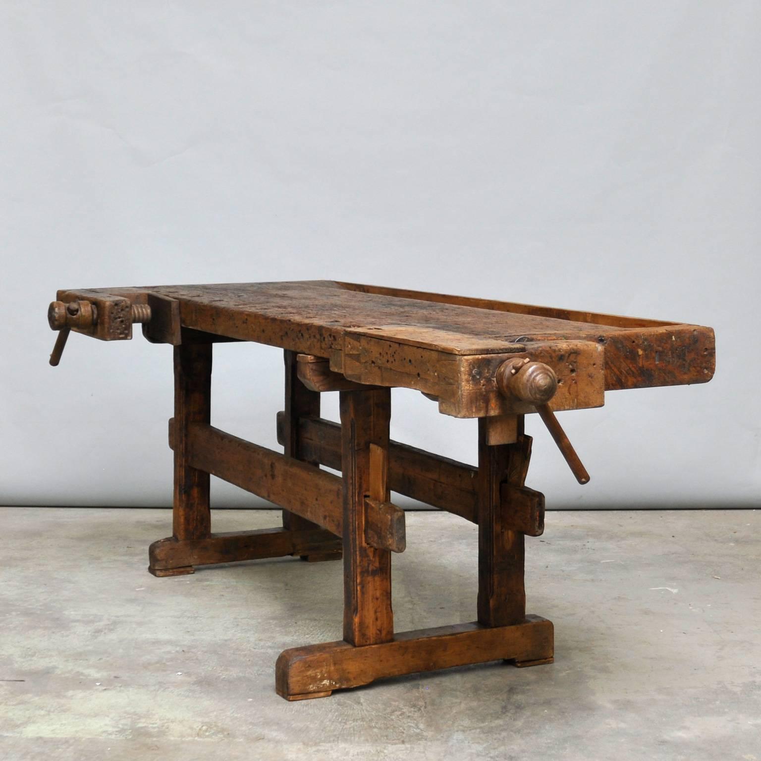 Antique Hungarian carpenters’ workbench, bearing a very nice patina after years of use. It has two vices with a wooden handle and a recessed tray where the carpenter would lay his tools. It has been restored and waxed.