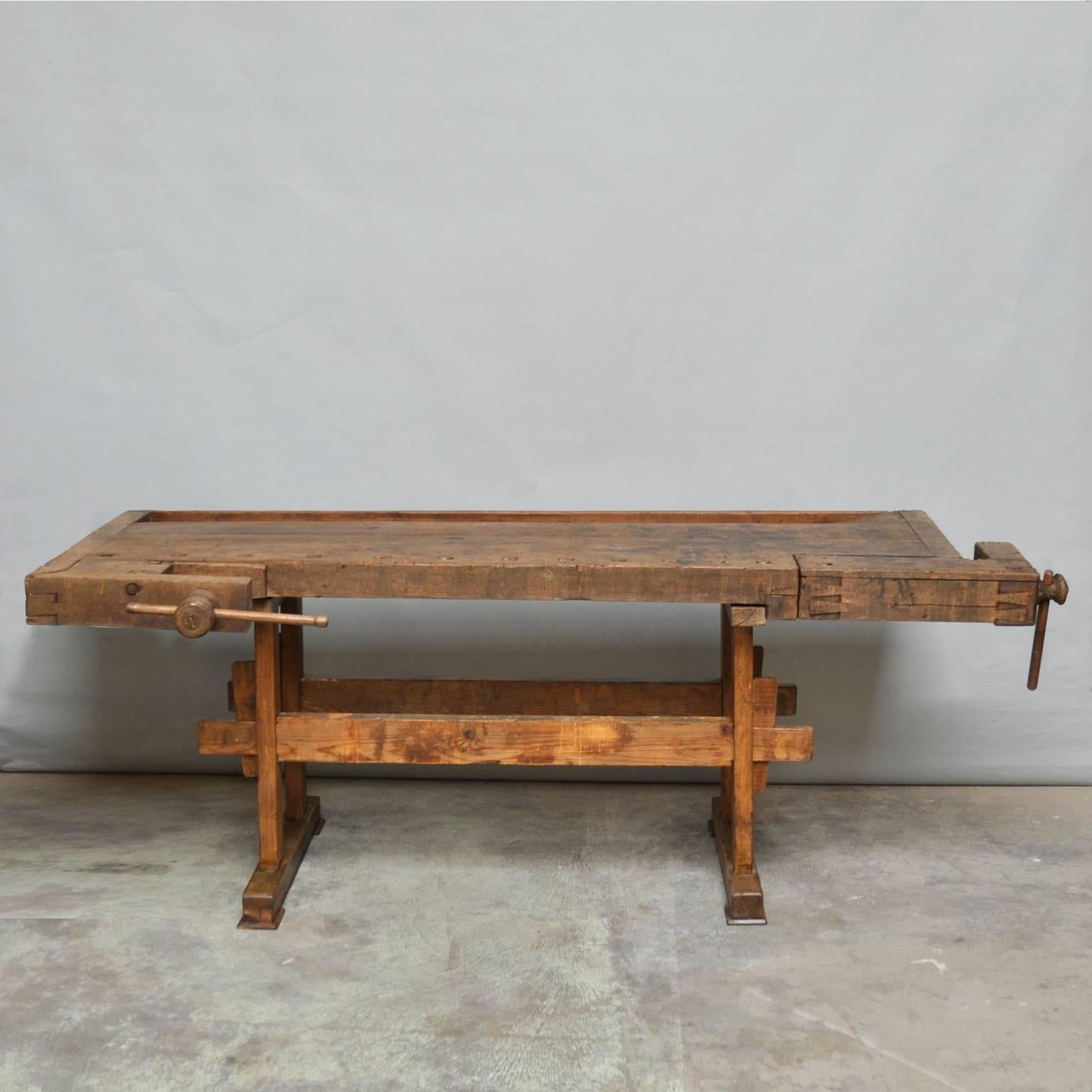 This vintage Hungarian carpenter’s workbench features two vices and a recessed tray where the carpenter would lay his tools. It was manufactured, circa 1935.