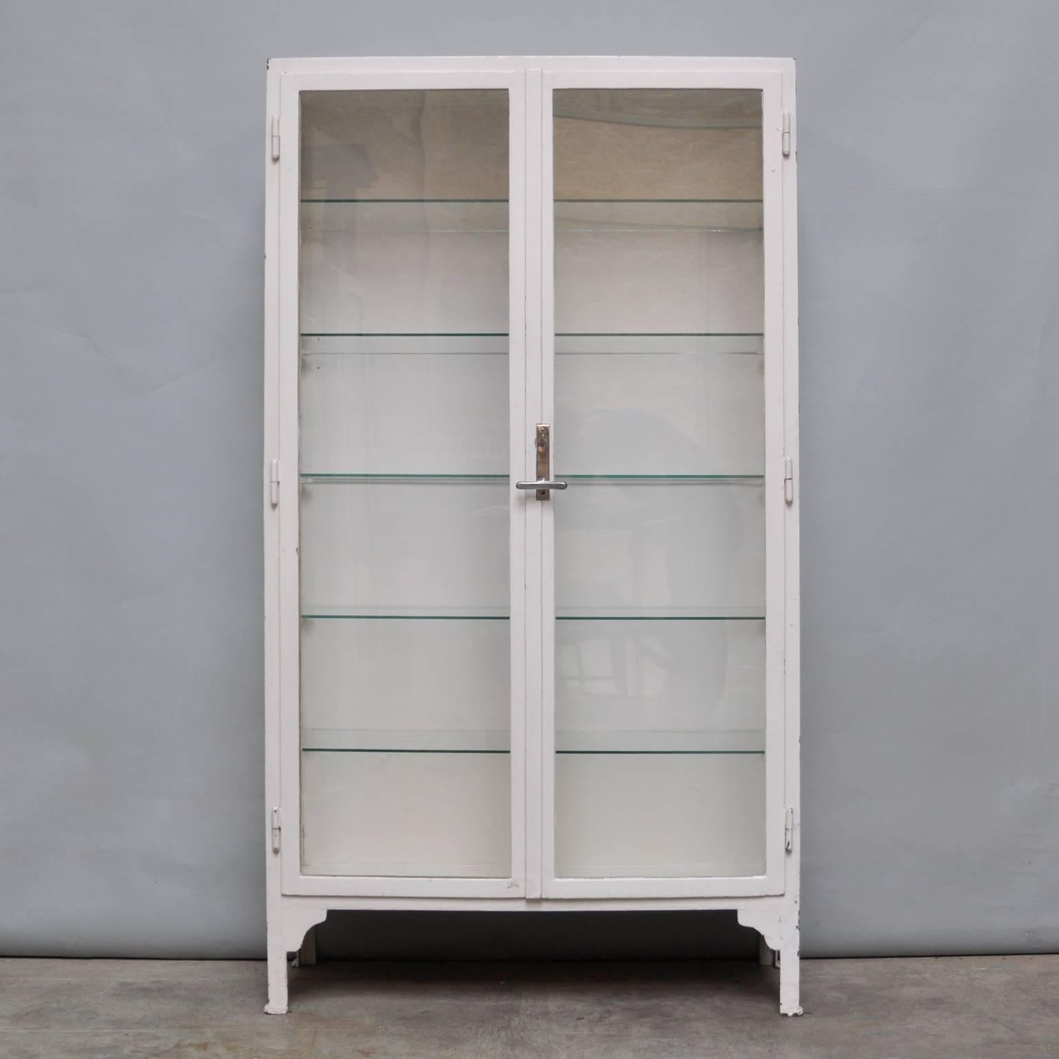 Medical cabinet produced in de, 1940s in Hungary
The cabinet is made of thick iron and antique glass
Features five glass shelves
Some chips of paint missing
The lock is original and functioning
In a good vintage condition.