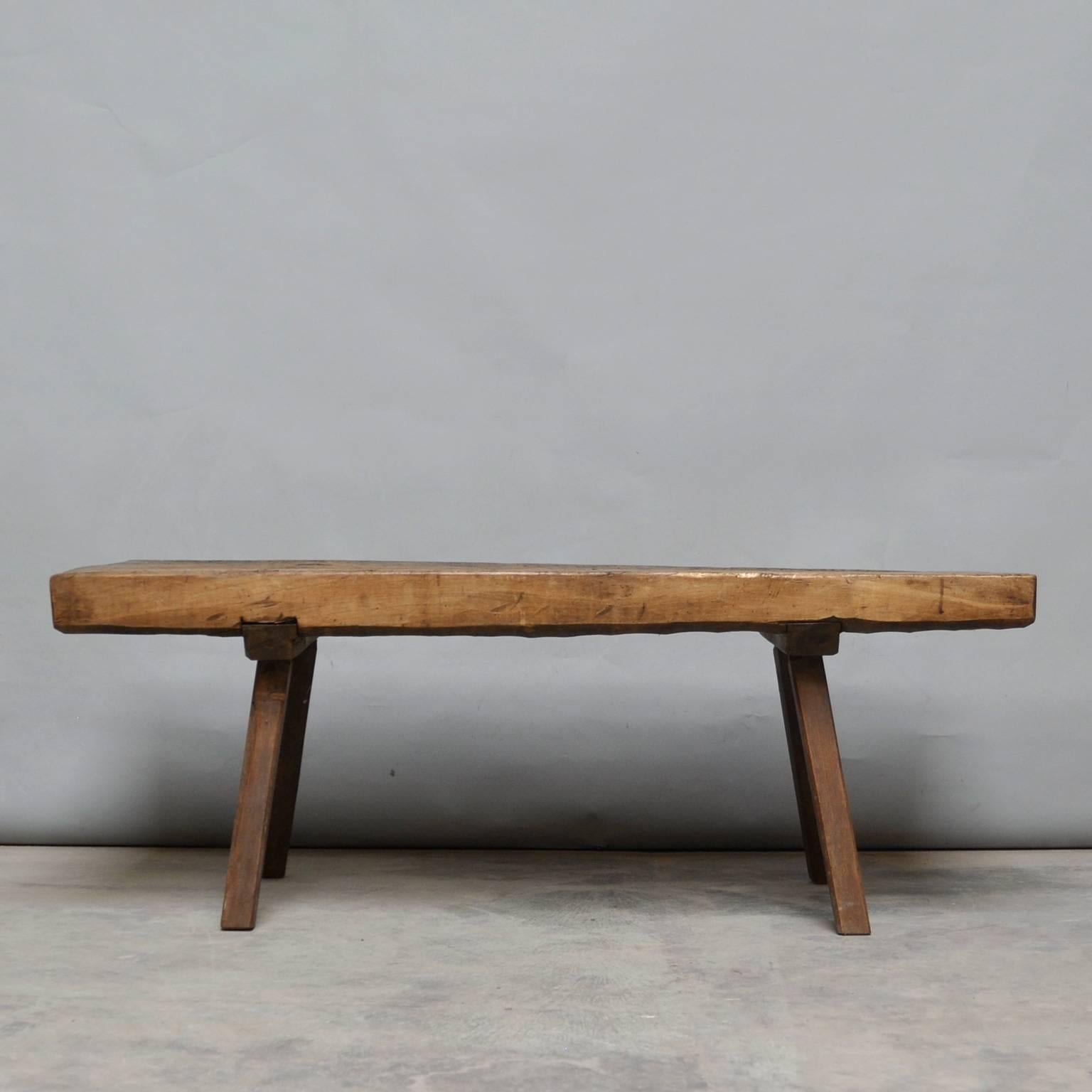 This oak butcher's block was produced in Hungary around the 1930s and has a 10 cm thick top. The piece features the original oak legs, and has been wax-finished. The legs has been cut down to a standard coffee table or bench size.