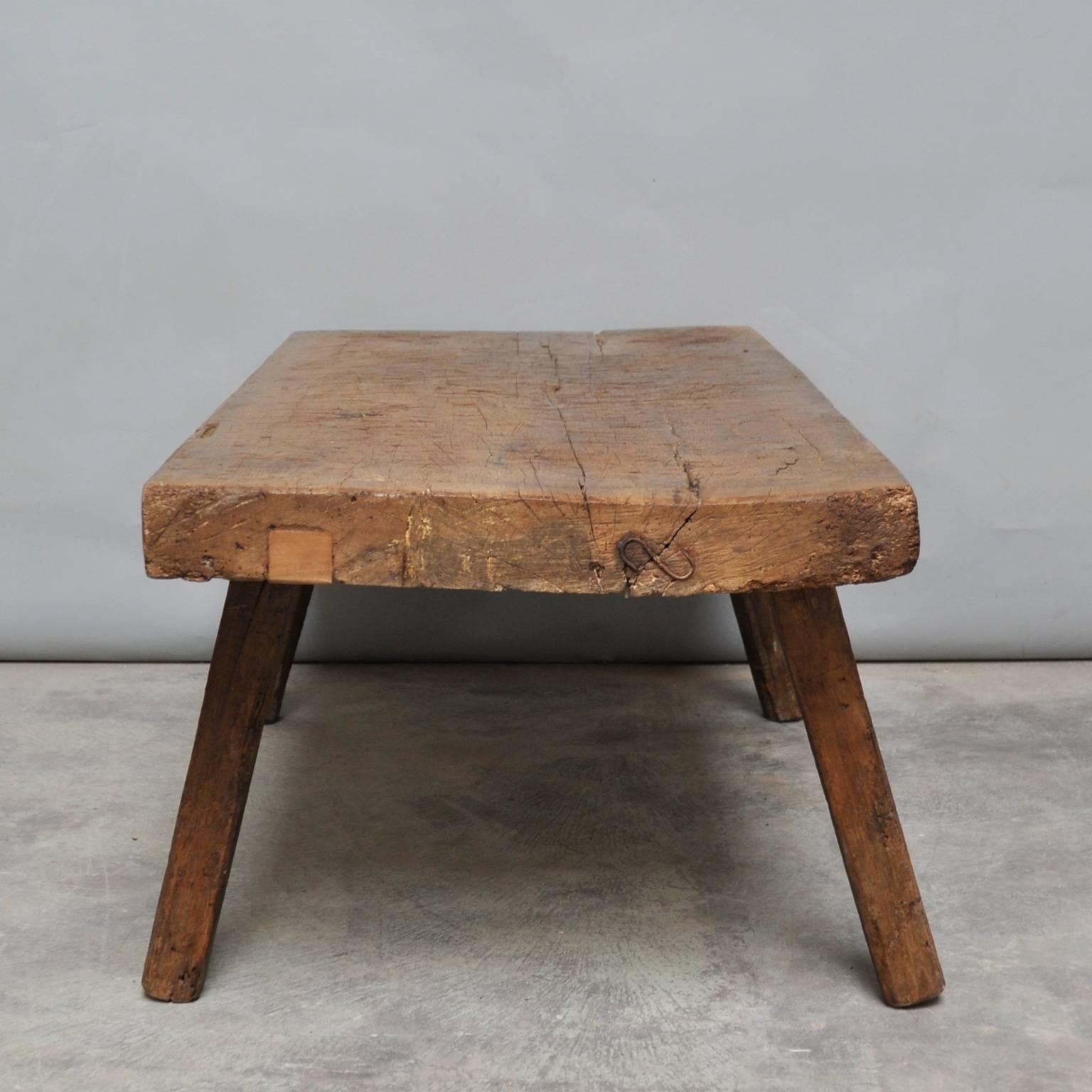 This oak butcher's block was produced in Hungary around the 1930s and has a 10 cm thick top. The piece features the original oak legs and has been wax-finished. The legs has been cut down to a standard coffee table or bench size.