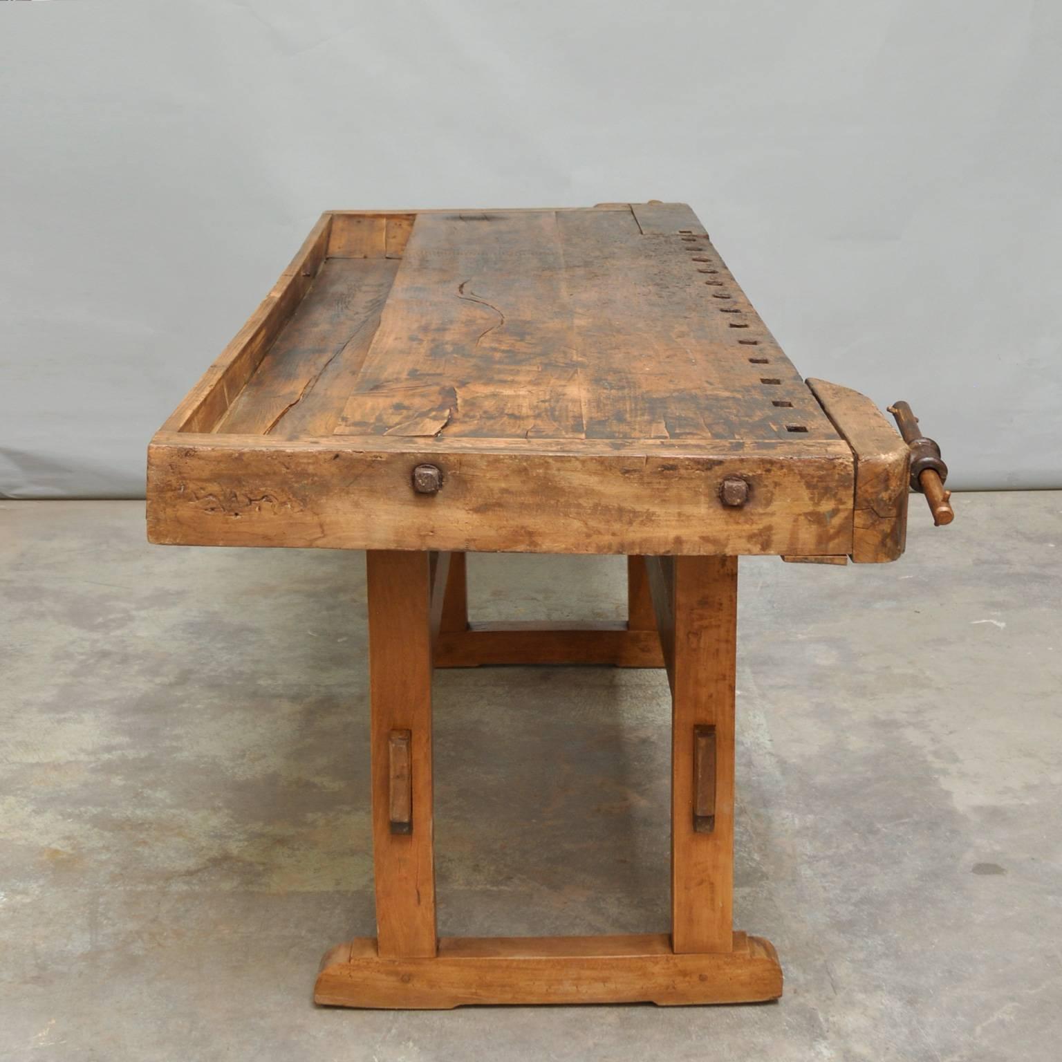 This vintage Hungarian carpenter’s workbench features two metal vices and a recessed tray where the carpenter would lay his tools. It was manufactured, circa 1935.