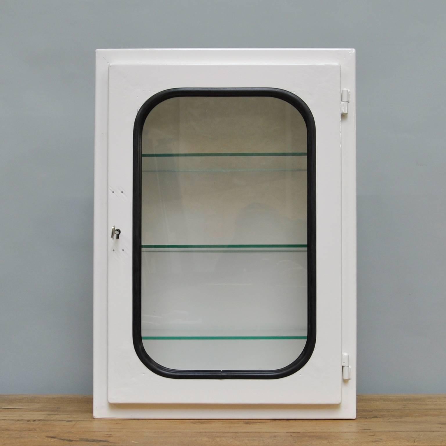 This medicine cabinet was designed in the 1970s and produced circa 1975 in Hungary. It is made of iron and glass, which is held by a black rubber strip. The cabinet comes with three adjustable glass shelves. The cabinet is restored (powder-coated).