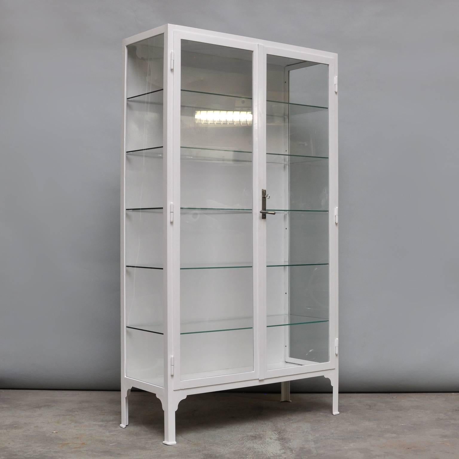 This medicine cabinet was produced in the 1940s in Hungary. The cabinet is made from thick iron and glass. It features five (new) glass shelves. In an excellent condition. The cabinet has been restored (very small crack in glass, see photo).