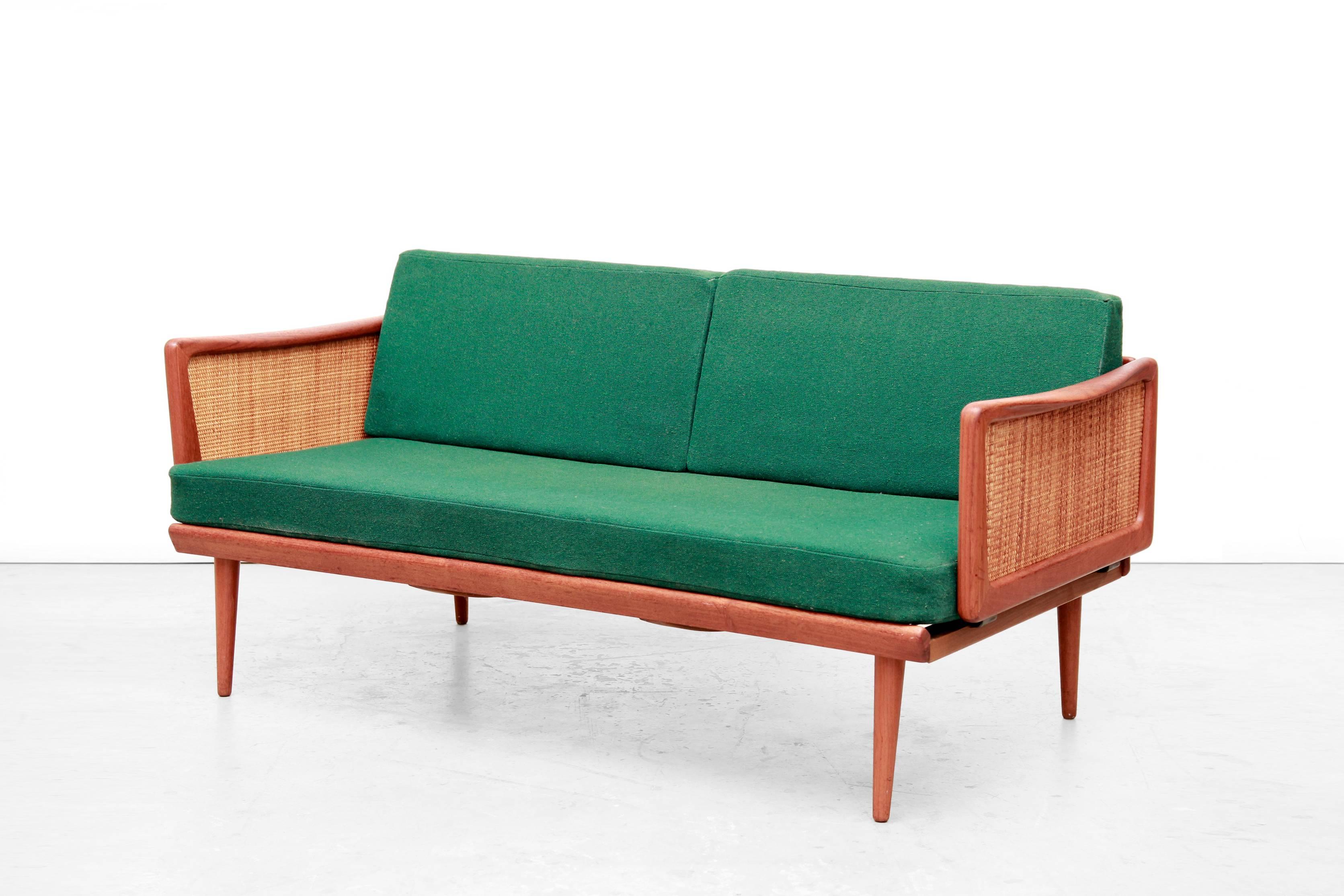 Particularly beautiful and rare sofa bed by Peter Hvidt & Orla Mølgaard Nielsen.
This daybed with modelnam FD 451 is produced by France & Daverkosen in Denmark. The frame is made of solid teak wood and is of very high quality, with woven cane