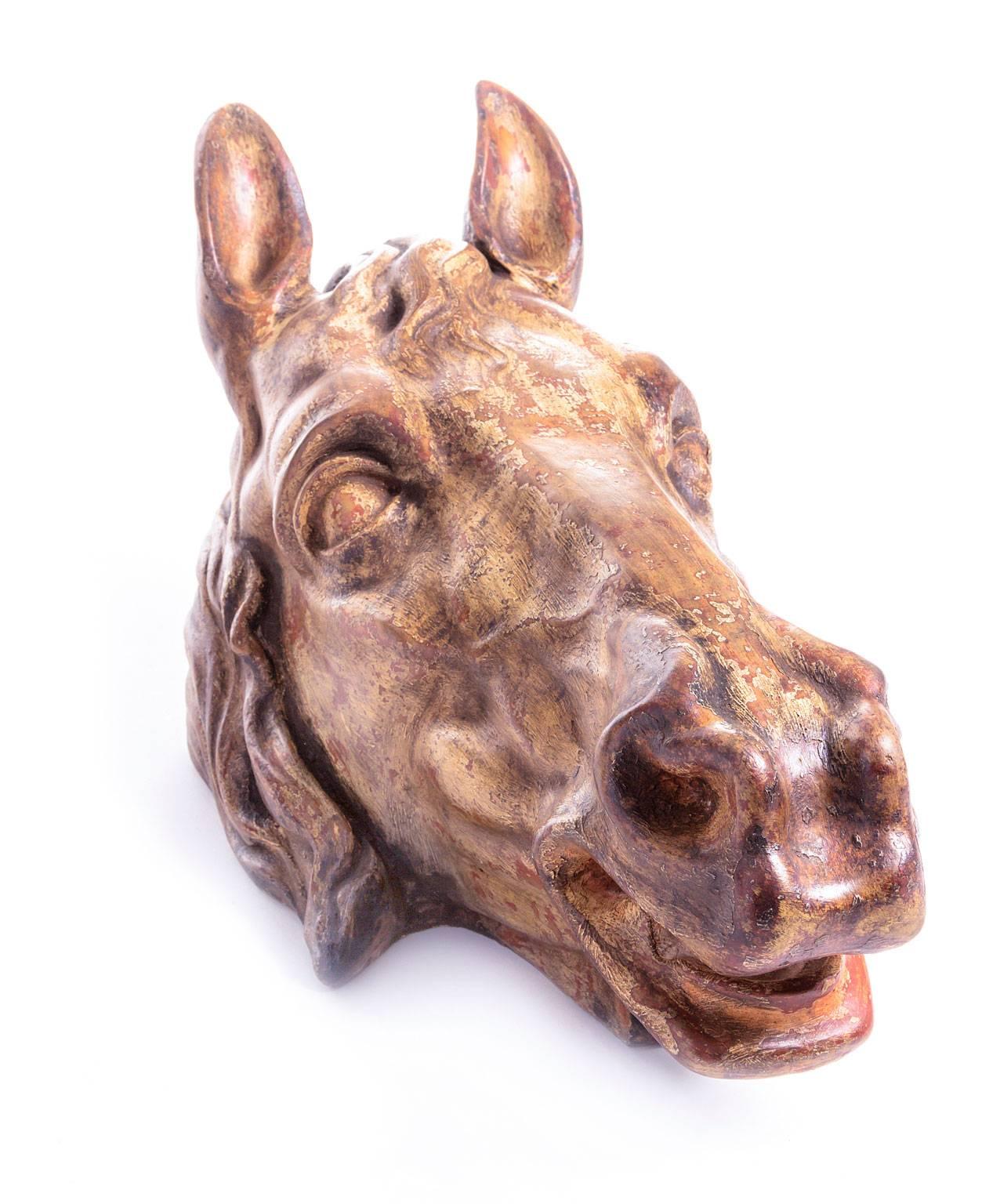 A wonderful lifesize horse head in faience with 'faux bois' finish, France, 19th century. This highly decorative piece most likely adorned the walls of important stables. It comes with a new wooden wall bracket.