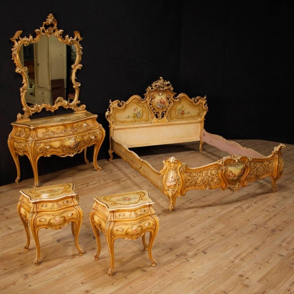Venetian double bed of the 20th century. Furniture in richly carved, lacquered, gilded and painted wood with little angels and scene of neoclassic style. Bed of fabulous decoration decorated by sides also golden and painted with flowers.