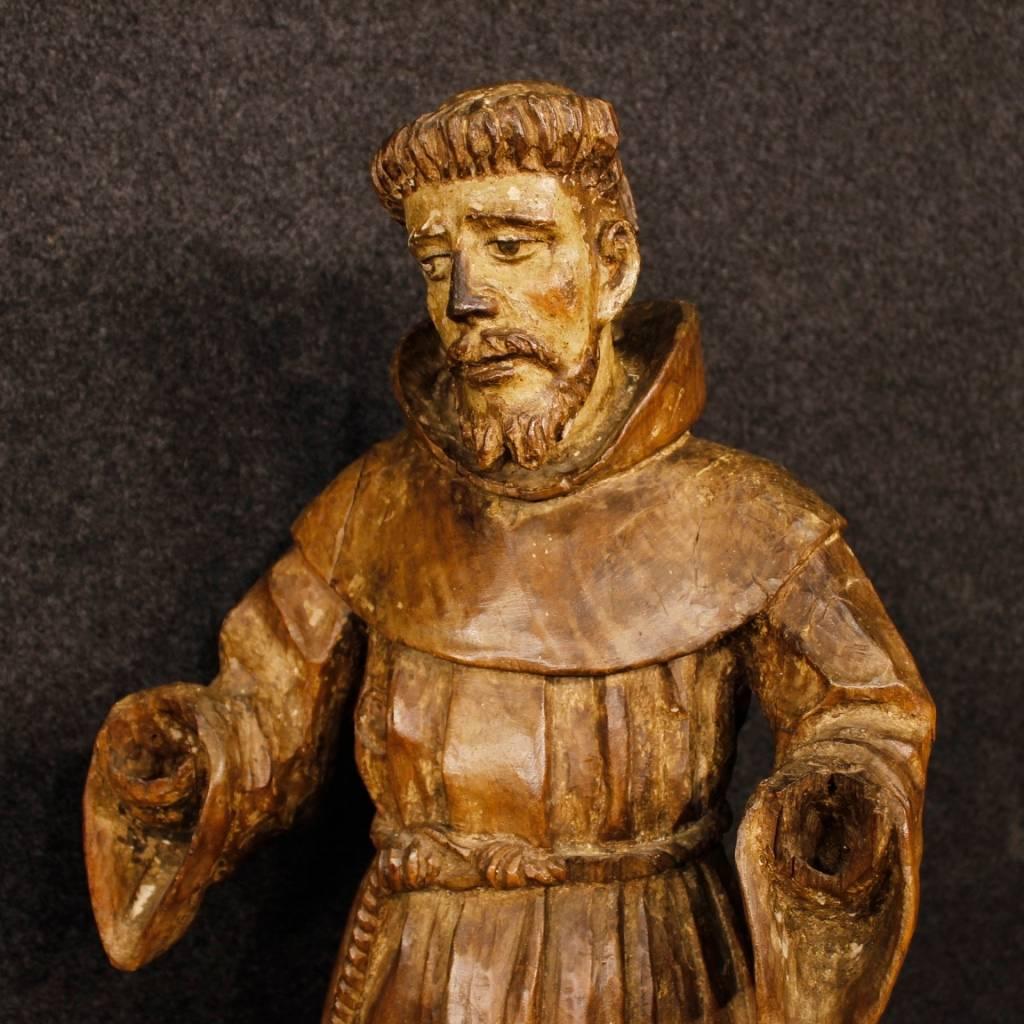 Antique French sculpture from 18th century. Statue in carved wood depicting the subject of sacred art "Saint Francis". Work in beautiful patina with some signs of antique lacquer on the face and on the tunic. Sculpture missing hands
