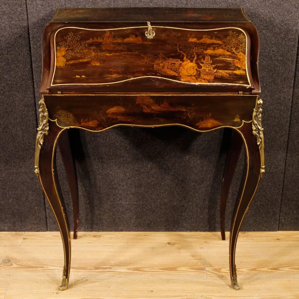 Small French bureau of the 20th century. Lacquered and painted wooden furniture with chinoiserie decorations. Bureau finished for the center decorated with golden and chiseled brass. Interior complete with two drawers, folding compartment and small