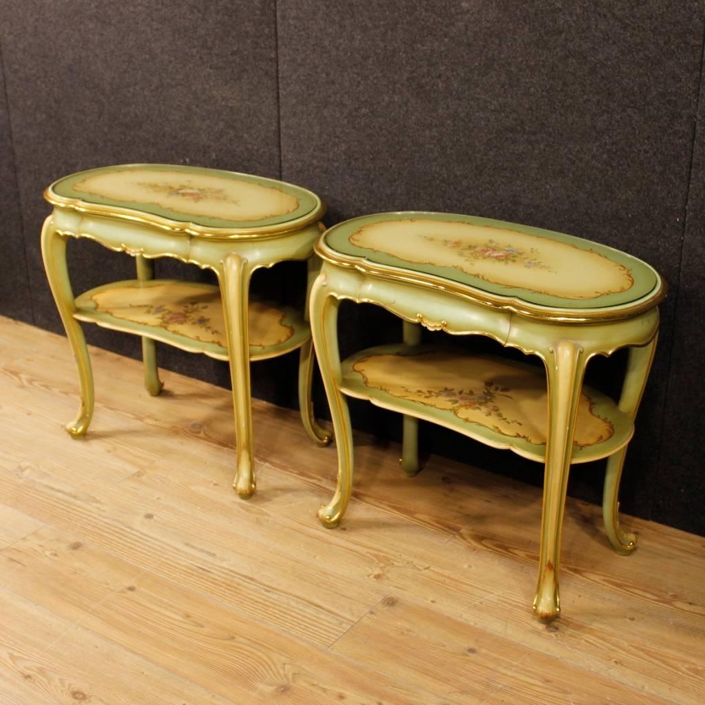 Pair of Italian bedside tables from the 20th century. Furniture in pleasantly carved, lacquered, golden and hand-painted wood with floral decorations. Night stands with a frontal drawer of discreet capacity. Top with protective glass of good quality