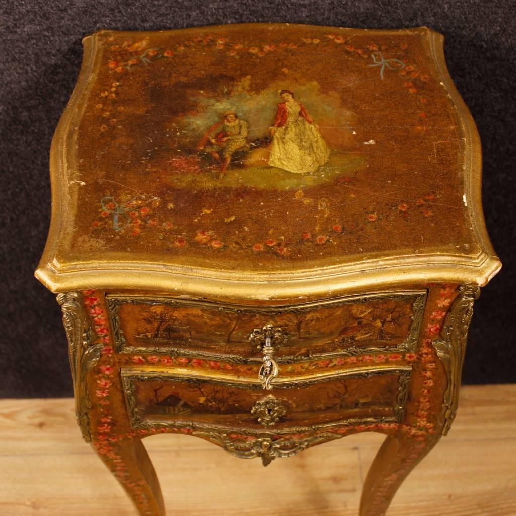 French nightstand of early 20th century. Furniture in richly lacquered, golden and painted wood in Vernis Martin style decorated with romantic landscapes and scenes. Side table finished for the center pleasantly adorned with golden and chiseled
