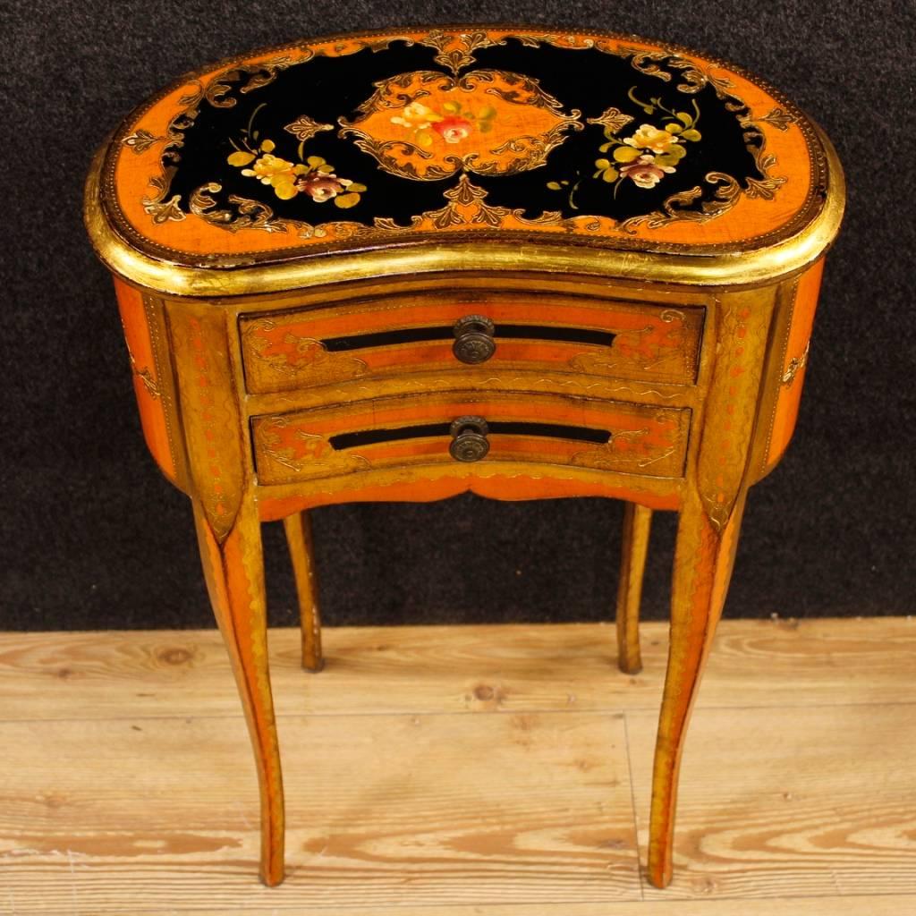Florentine side table from 20th century. Furniture finished for the center in richly lacquered, golden and painted wood with chiselled decorations. nightstand with two frontal drawers and top of good measure and service. Side table that can be