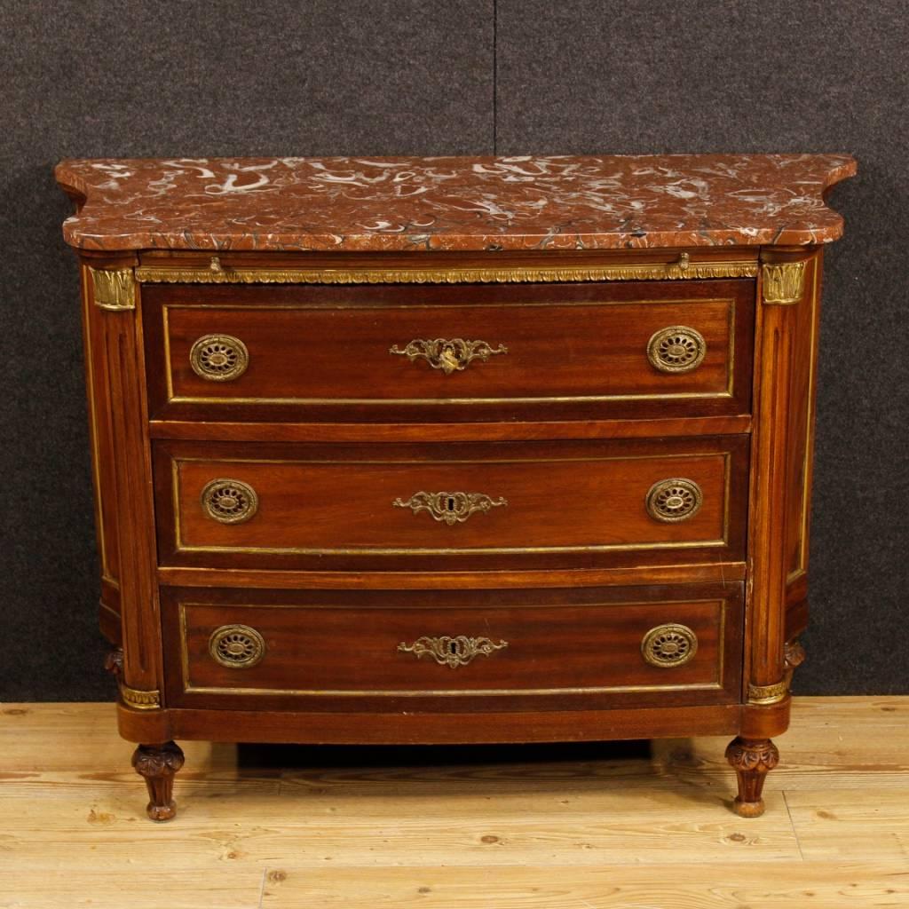 French dresser from the mid-20th century. Furniture in Louis XVI style made of mahogany wood, decorated with golden and chiseled bronze and brass. Commode with three drawers of good capacity and service complete with a working key. Furniture with an