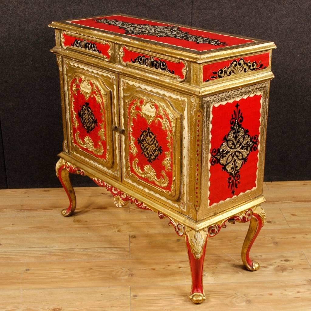 Florentine sideboard of the 20th century. Furniture in chiselled, lacquered, golden and silvered wood of beautiful decoration. Sideboard with two doors and two drawers of good capacity and service, it can be easily inserted at different points of