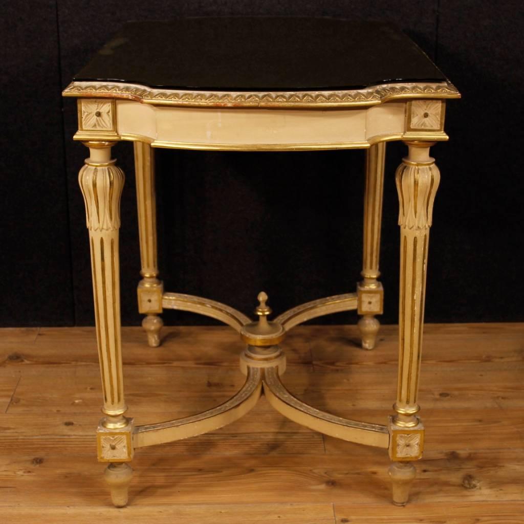 Italian lounge side table from the early 20th century. Furniture in Louis XVI style in carved, lacquered and golden wood. Side table of nice decor with top not original. The marble top has been replaced by a glass top with signs of wear and color