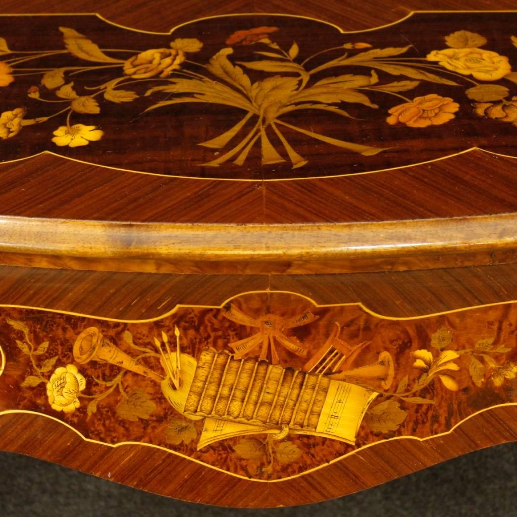 Italian console table of the 20th century. Furniture richly decorated with floral and musical instruments inlay in rosewood, maple, burl, tulip wood and fruitwood. Console of beautiful decoration with frontal drawer, of good capacity and service.