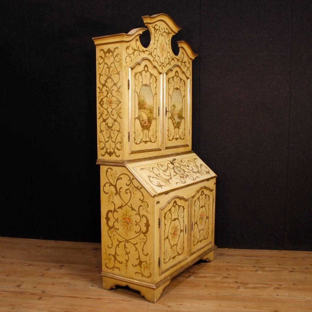 Venetian trumeau of the 20th century. Double body furniture in lacquered, painted and giltwood decorated with floral decorations and landscapes, of fabulous decor. Trumeau for a salon or studio of beautiful decoration, with two doors and bureau in